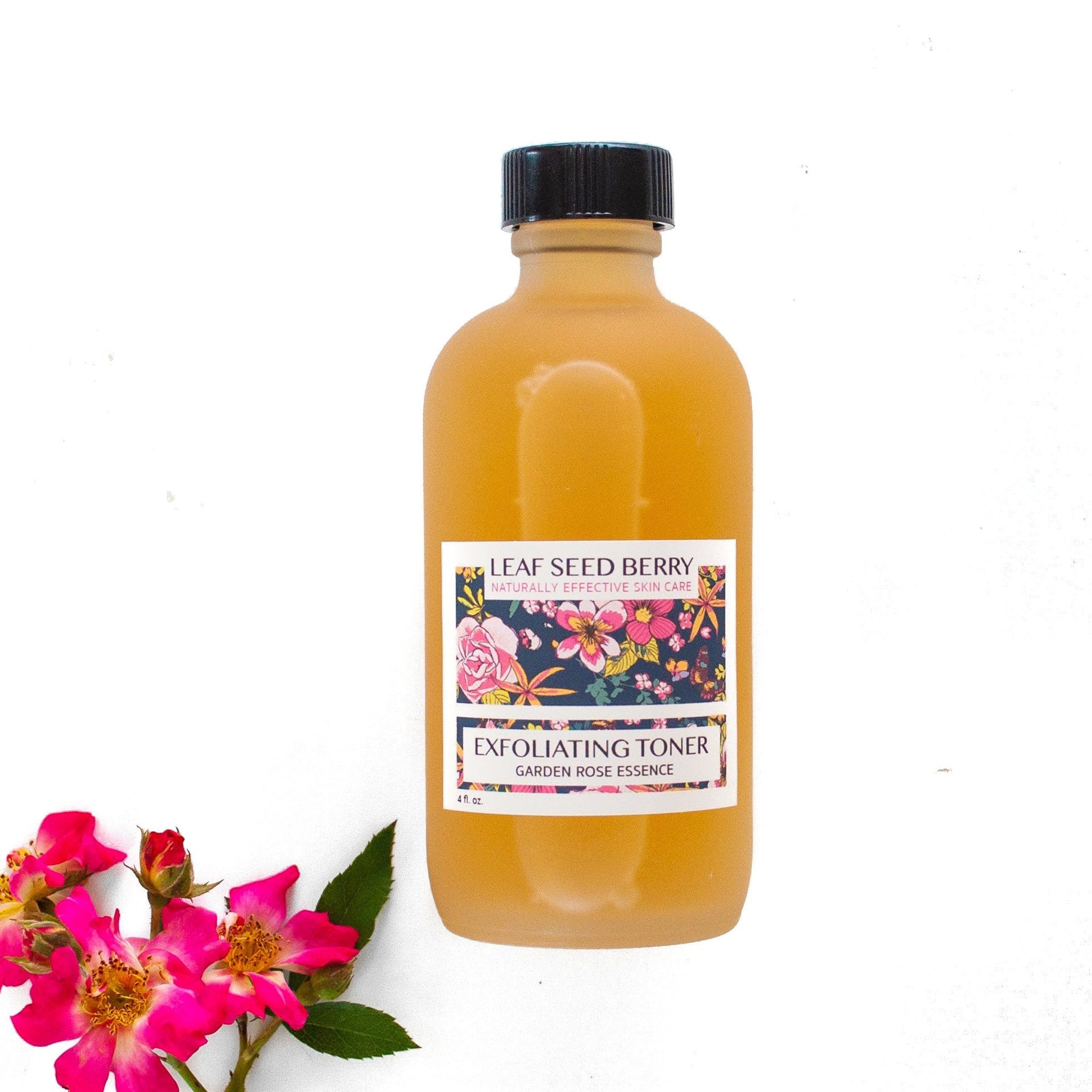 Exfoliating toner bottle, amber liquid, black cap, floral label with brand name