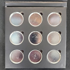 Side view of matte black magnetic eyeshadow palette showing nine square pans in neutral shades