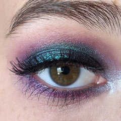 Close-up of shimmering masquerade eye shadow palette with vibrant jewel tones and smooth satin finish
