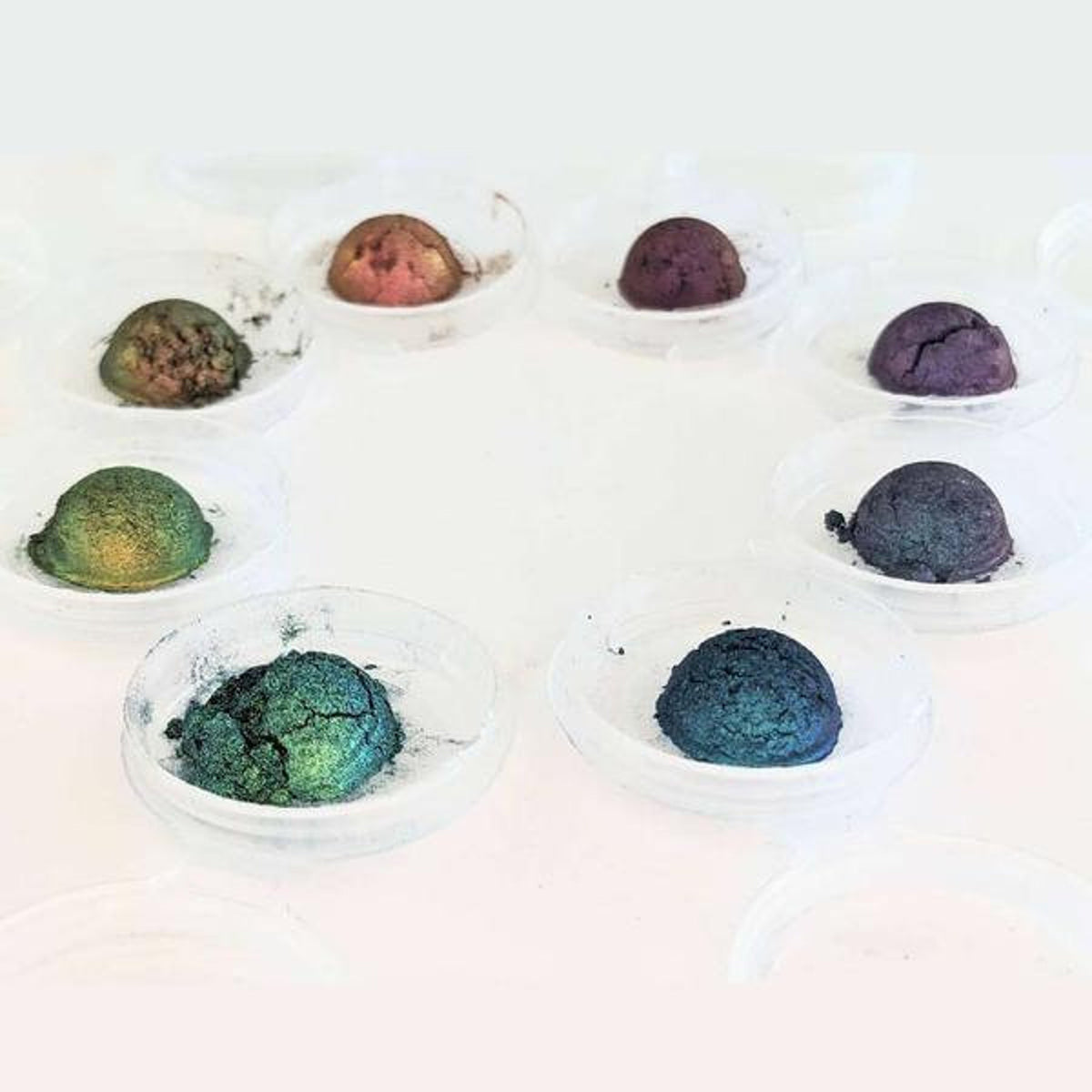 Close-up of multichrome eyeshadow bundle showing shifting iridescent hues in compact pans