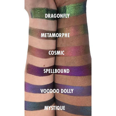 Hand applying multichrome eyeshadow with fingertip, showing vibrant color shift on eyelid