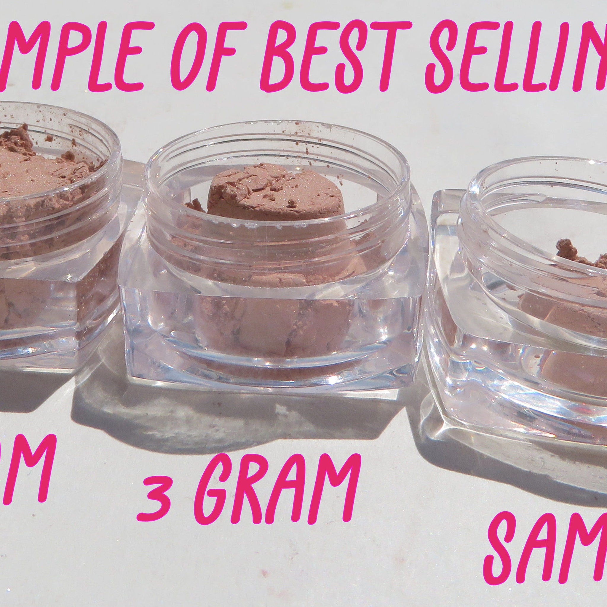 Powder samples in clear plastic jars with pink powder, white surface, and pink text