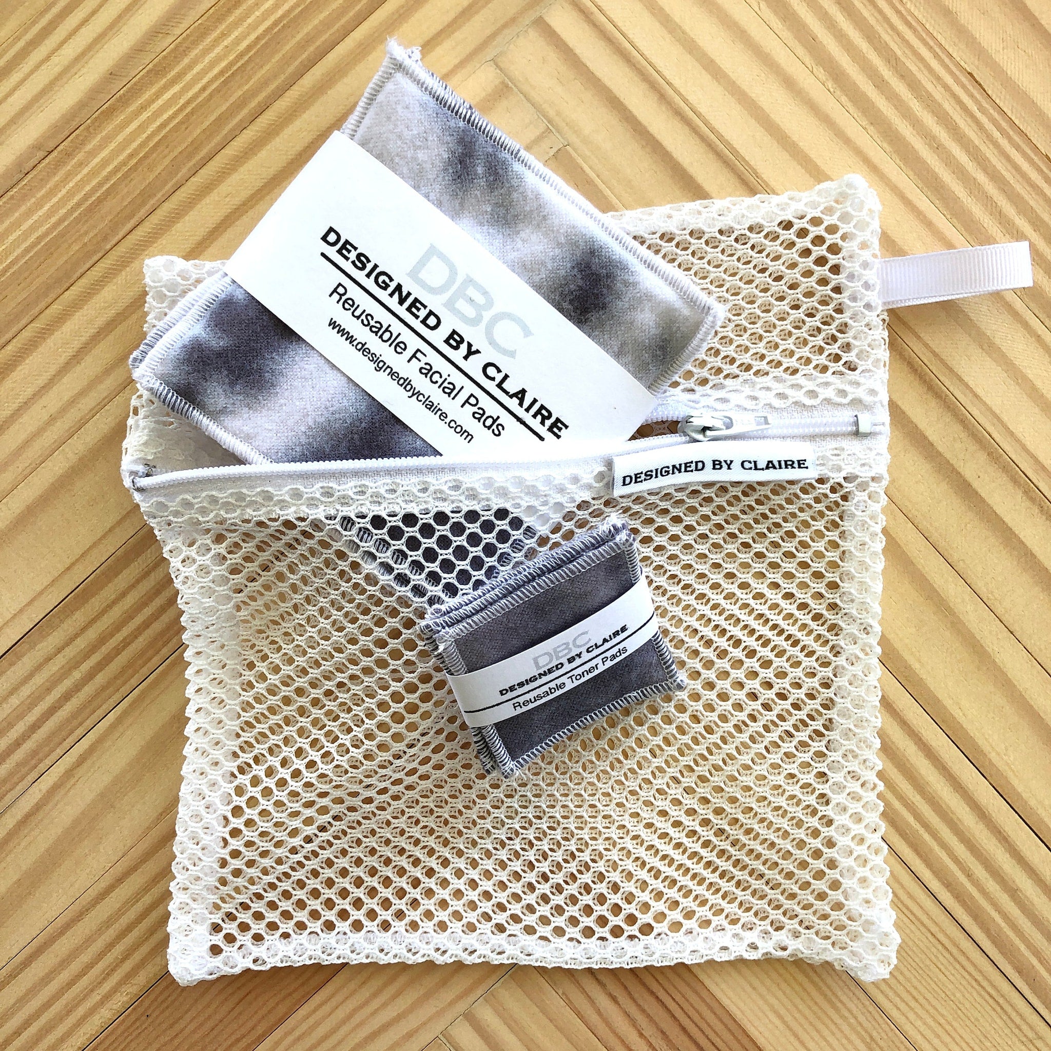 Reusable facial pads with gray and white pattern inside a white mesh bag, DBCDesignedByClaire brand