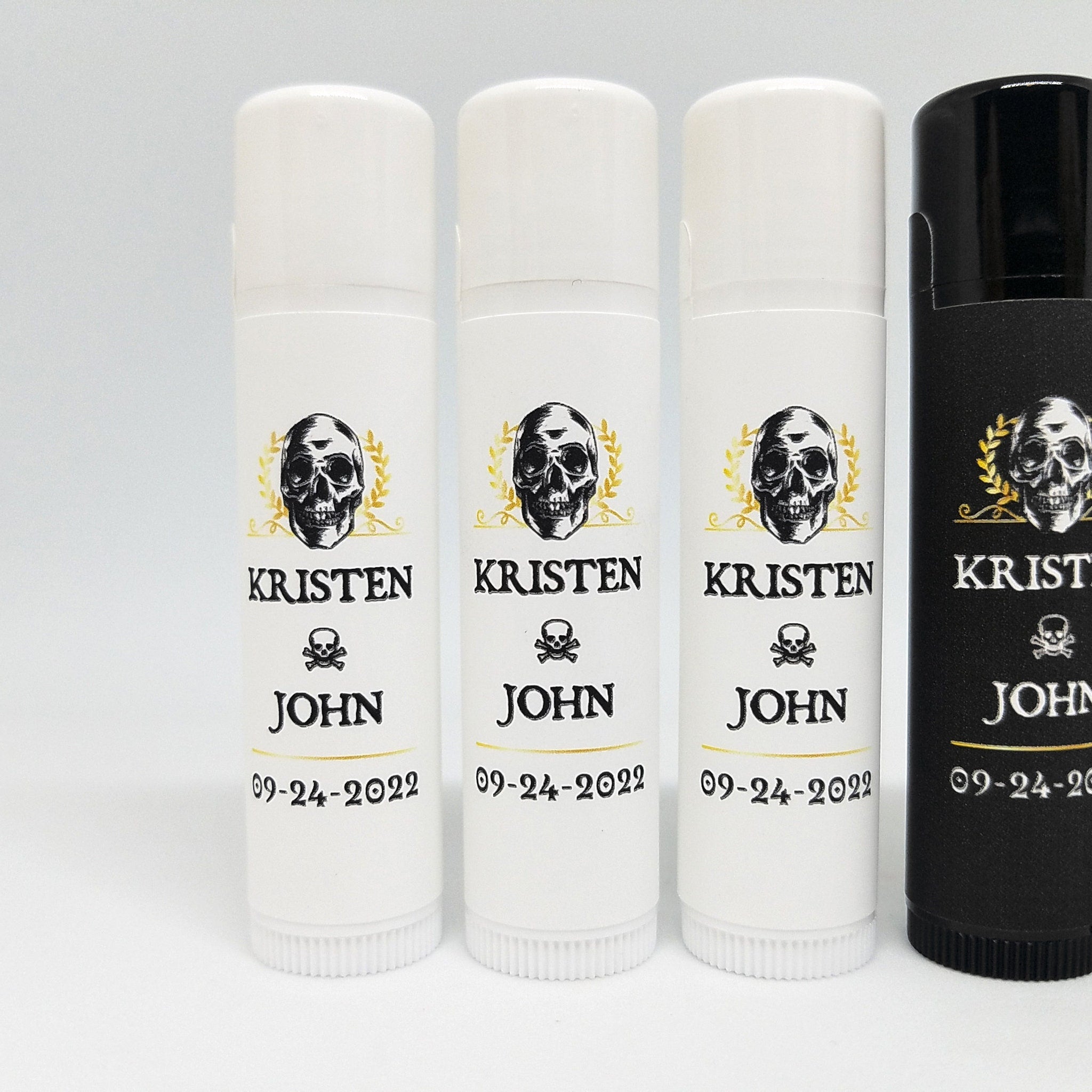 Lip balm tubes with white and black tubes, skull graphic, and text "KRISTEN JOHN