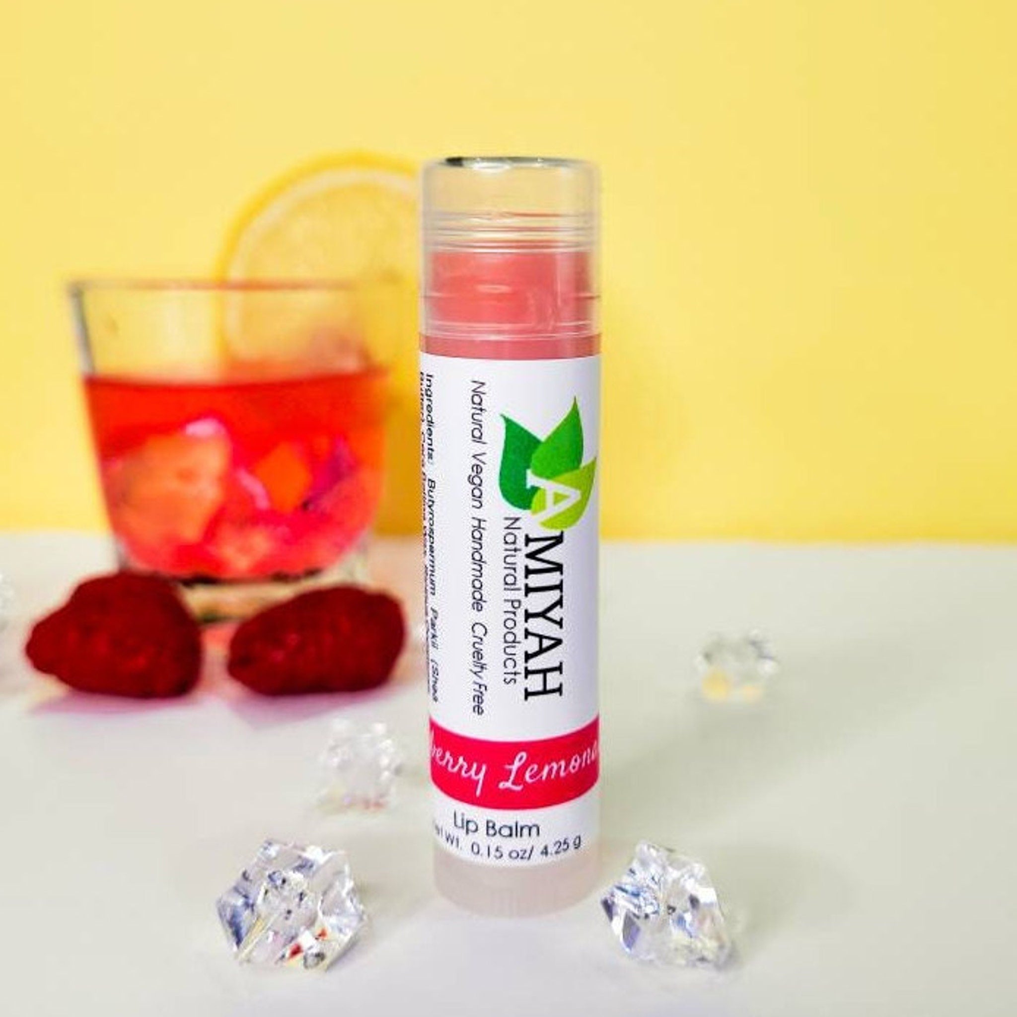 Lip balm tube with pink product, white label, and Amiyah Natural Products text, Berry Lemon flavor shown