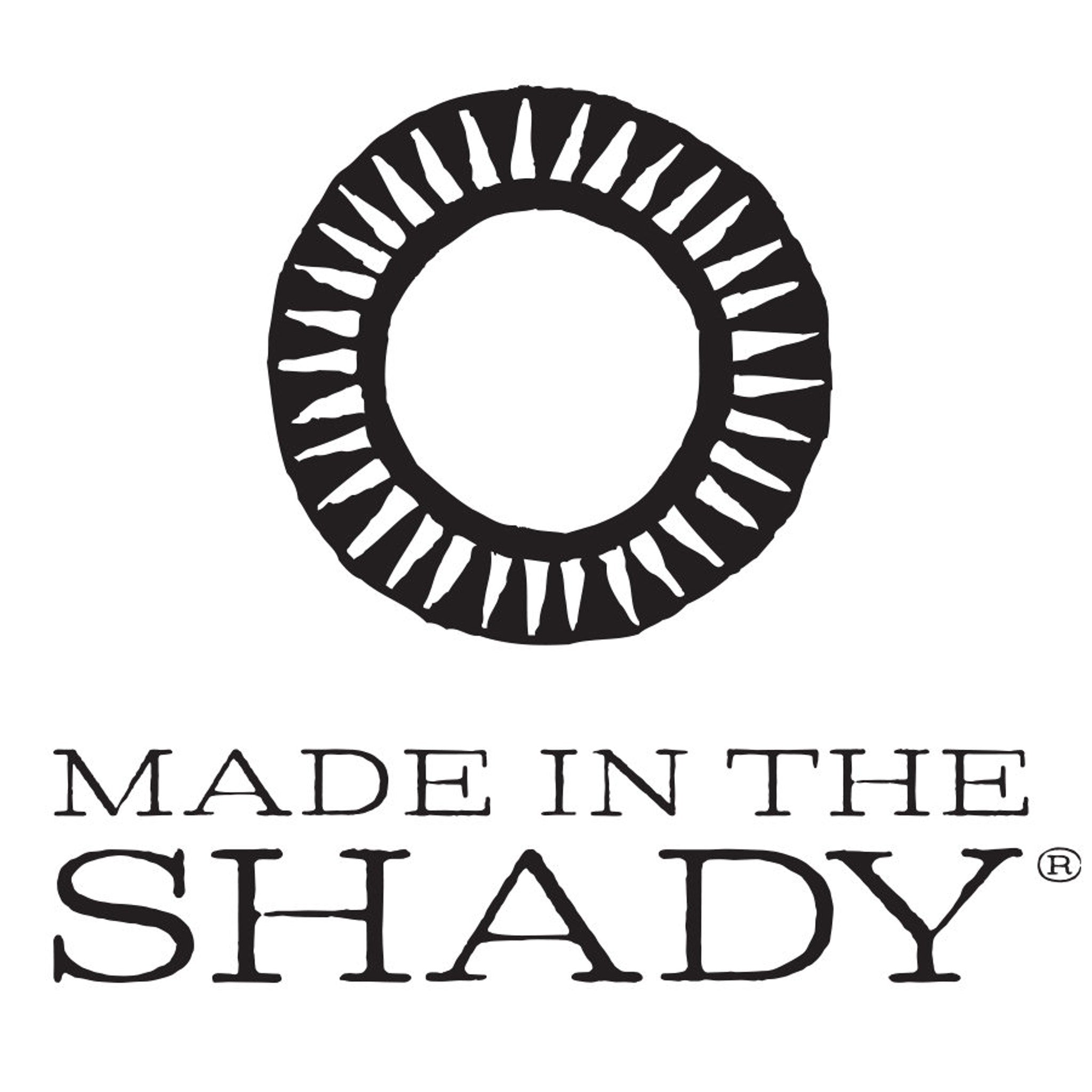 MADE IN THE SHADY logo, black and white circular design, brand text below