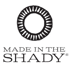 MADE IN THE SHADY logo, black and white circular design, brand text below
