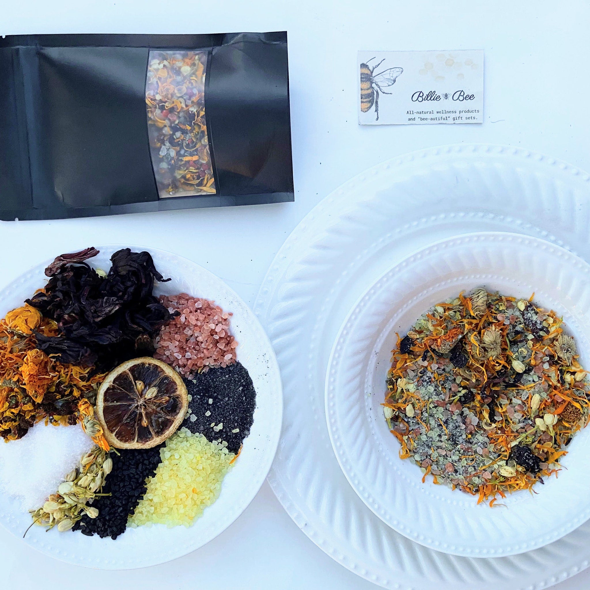Wellness product assortment with black pouch, white plates, and Billie Bee branding