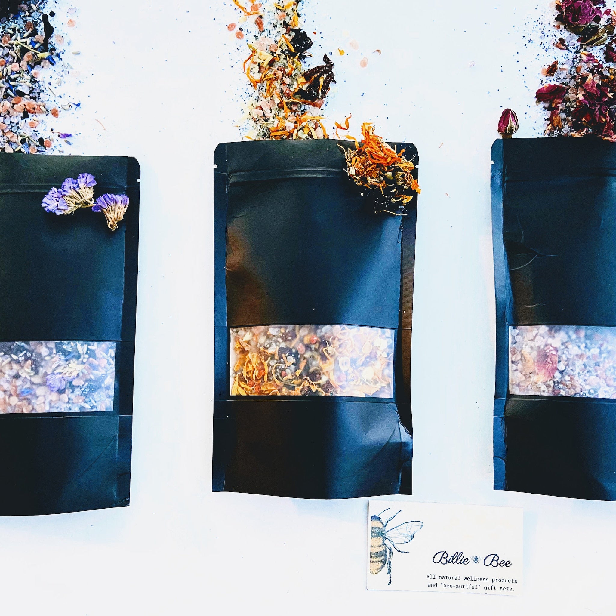 Black pouches with clear window, dried flowers, and Billie Bee branding