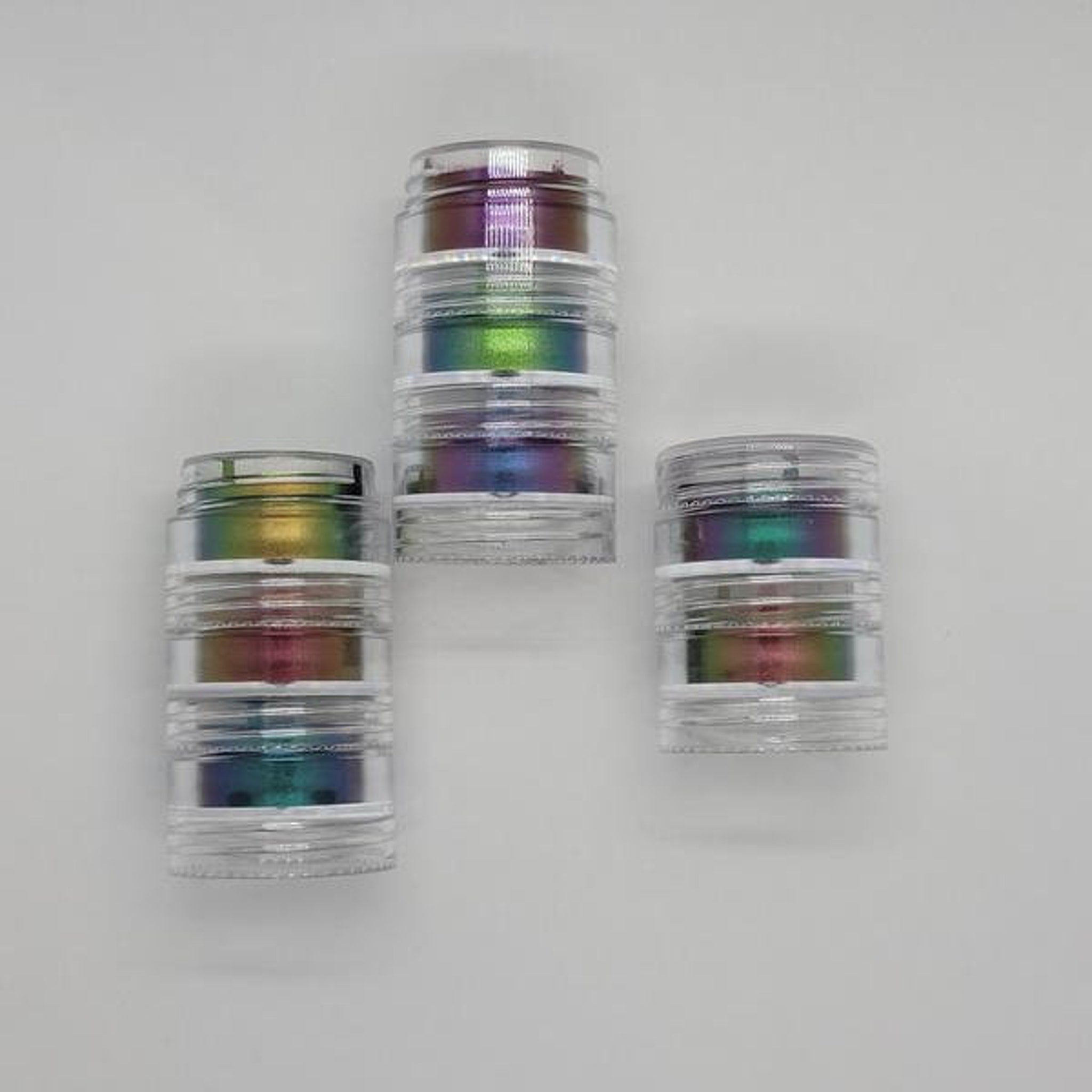 Side view of multichrome eyeshadow bundle showing shifting iridescent hues in compact pans