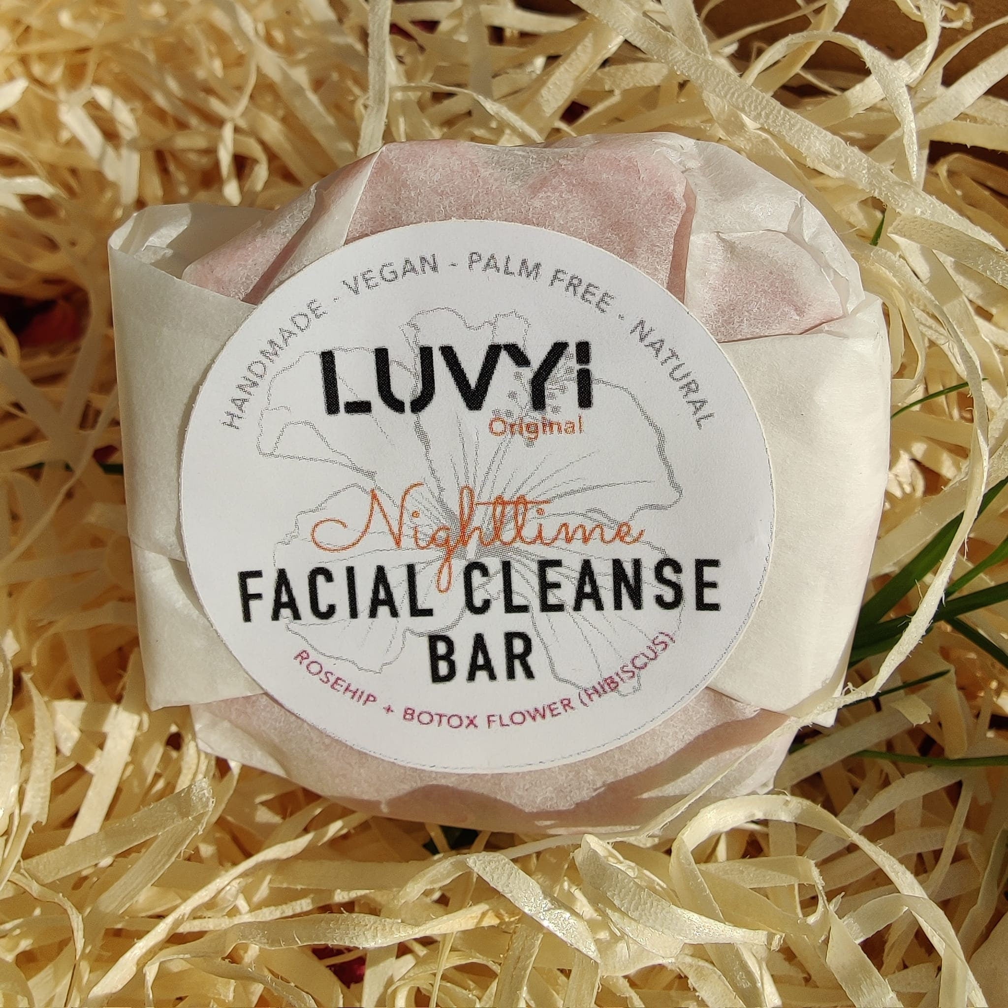 Facial Cleanser Bar wrapped in white paper, pink bar, Luvyi Nighttime label