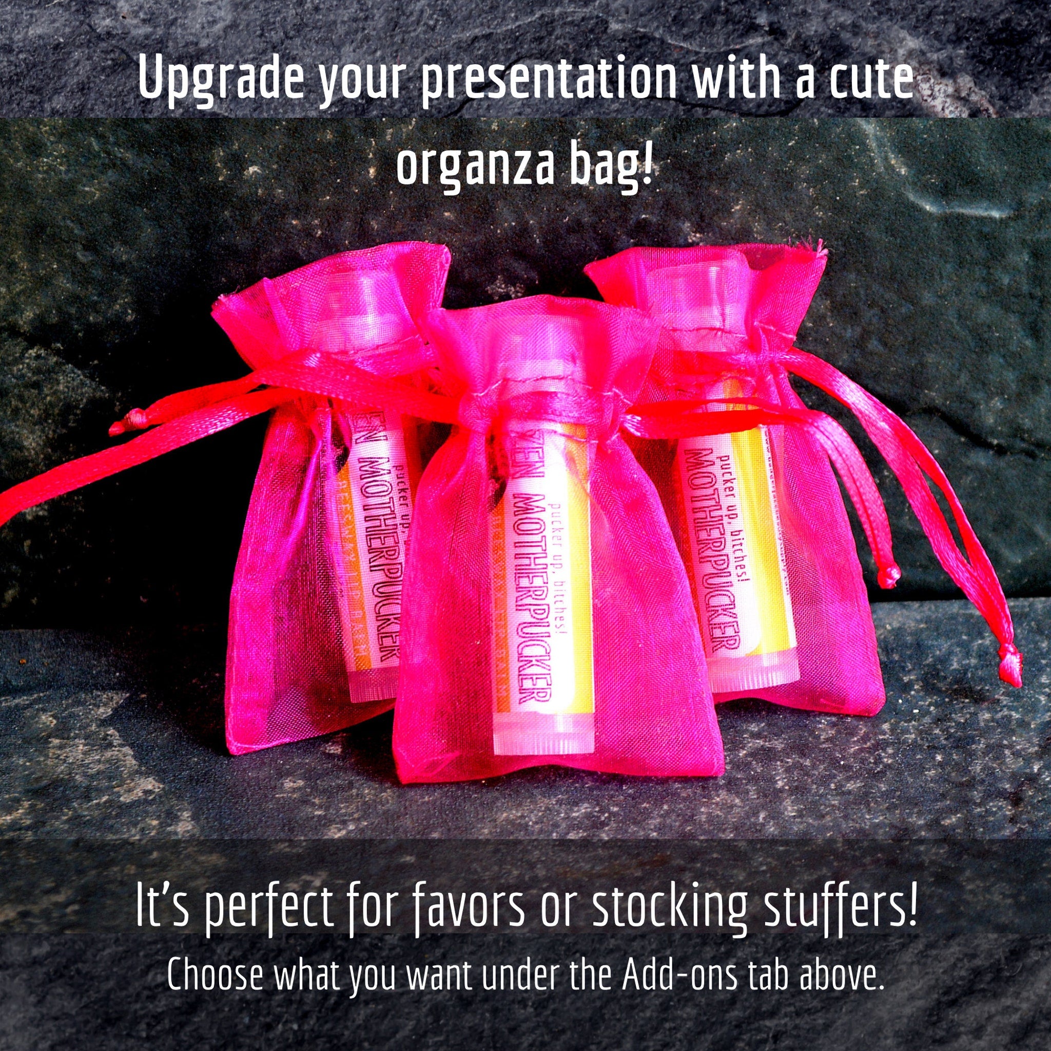 Organza gift bags with pink mesh and red ribbon, holding lip balm tubes