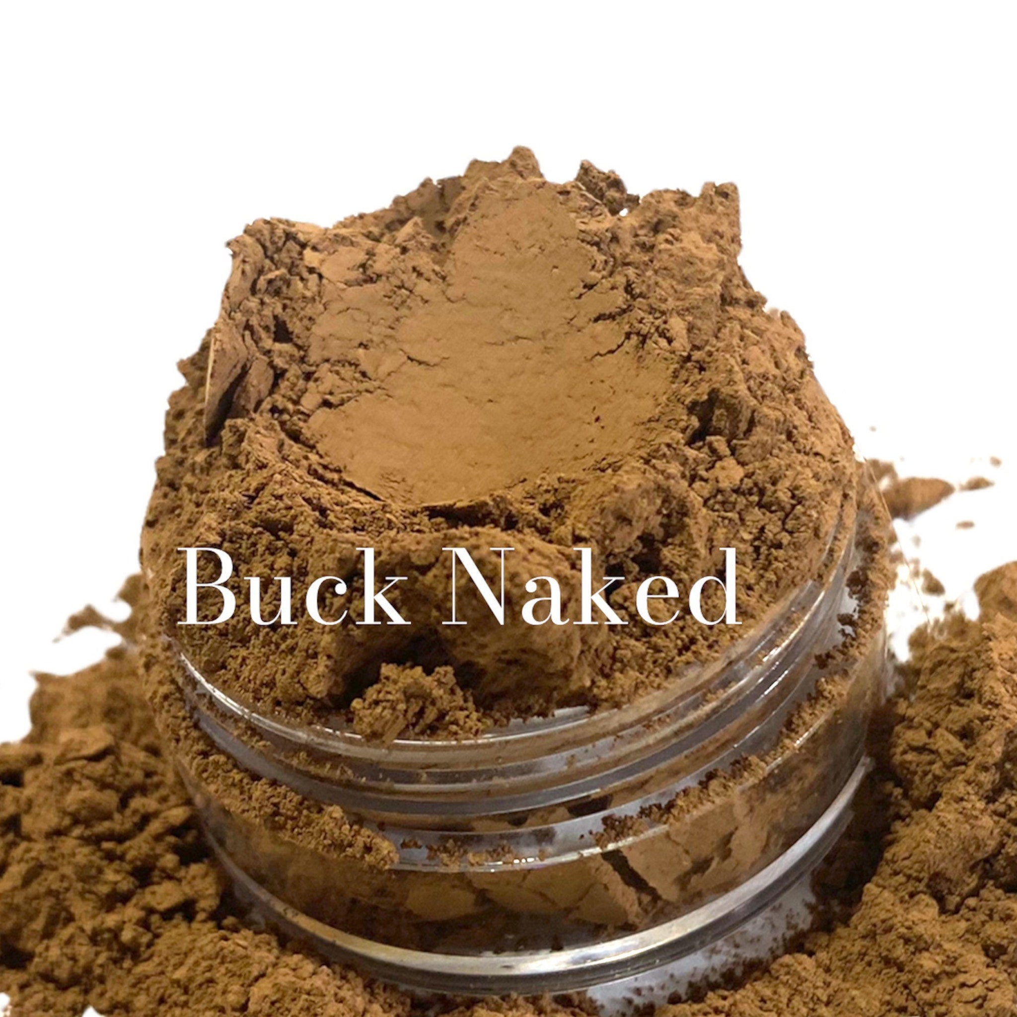 Side view of matte cinnamon brown eyeshadow pan showing mineral texture and compact size