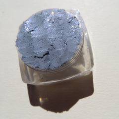 Close-up of sparkling Galactic Blue Gray loose mineral eyeshadow with shimmering mica particles