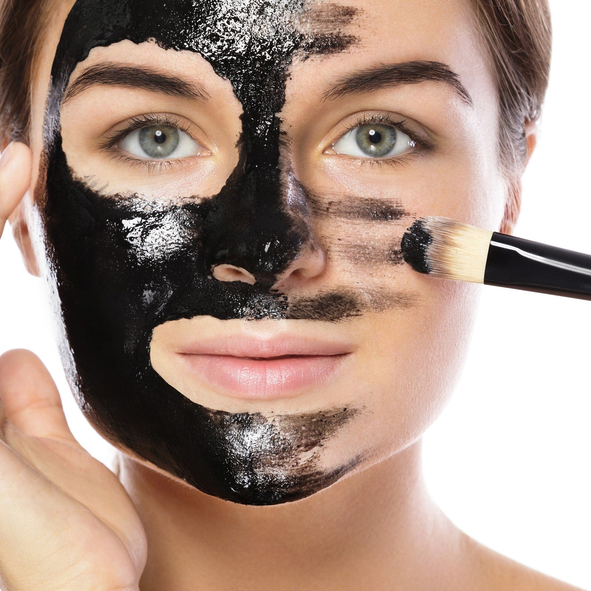 Close-up of black charcoal mask in a jar with smooth texture and matte finish