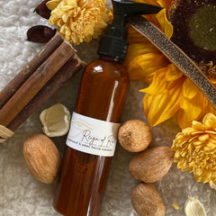 Facial cleanser bottle with brown liquid, black pump, and Reign of Ras label on white background