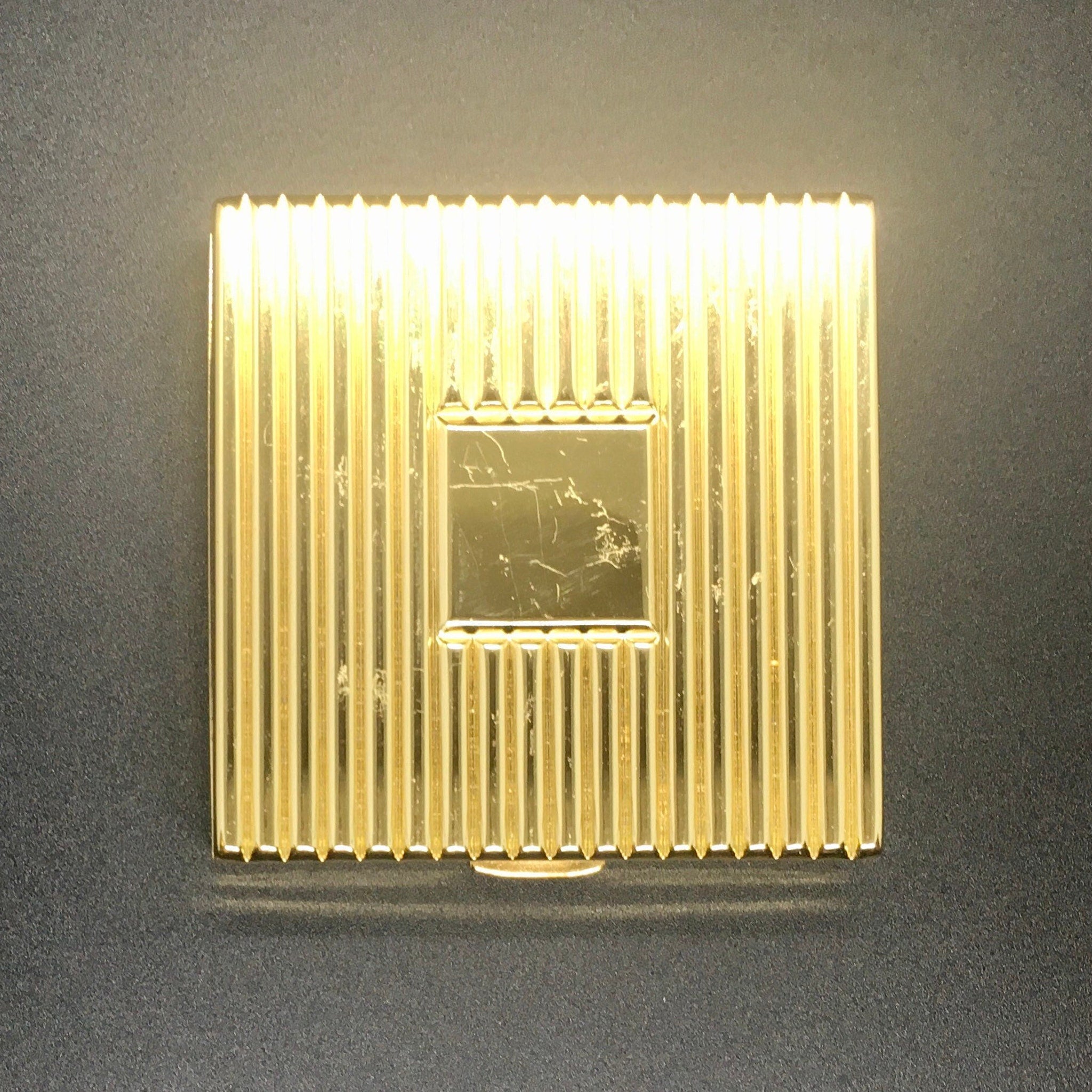 Face powder compact, gold-tone metal with ridged pattern and square center detail