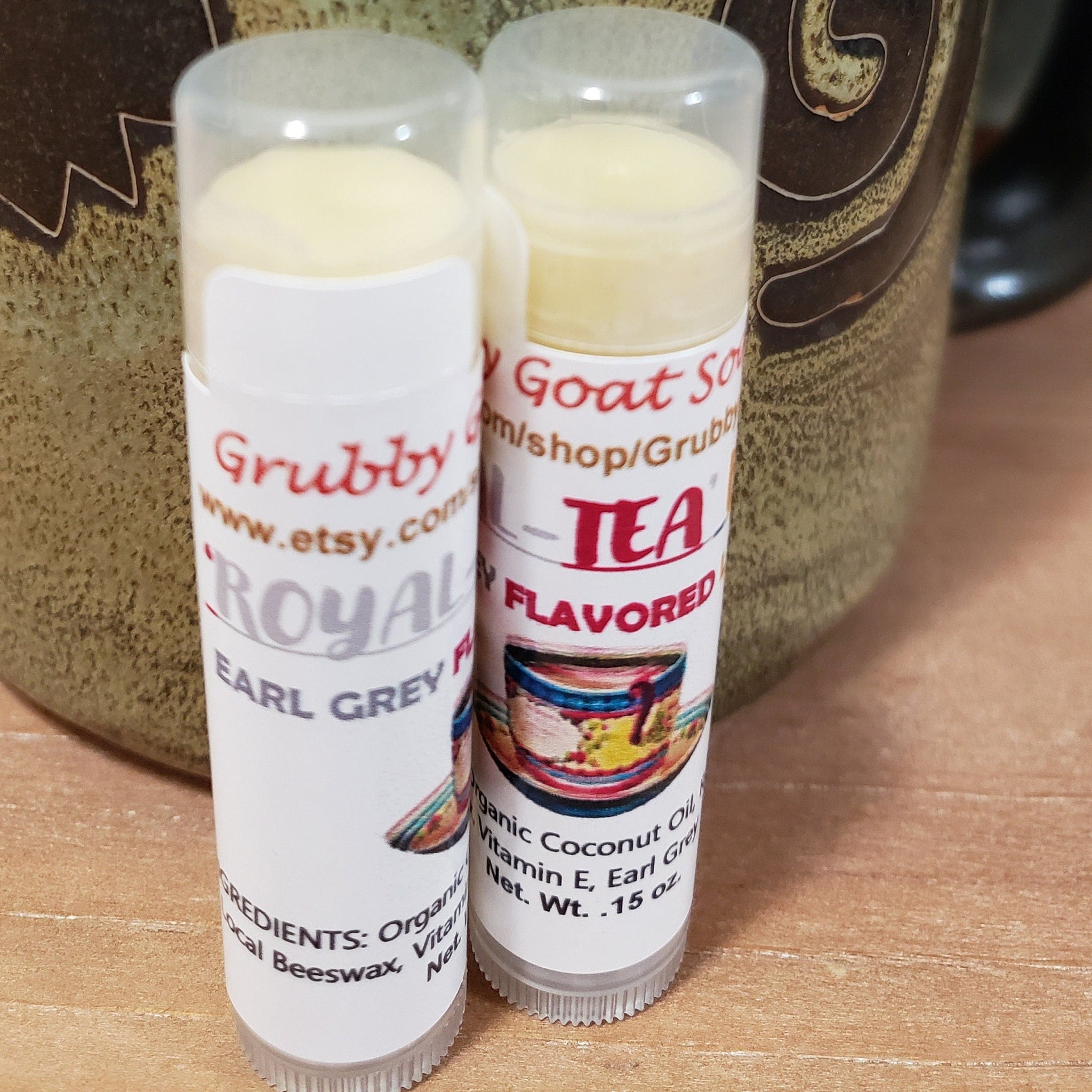 Lip balm tubes with white labels, Grubby Goat Soap branding, and clear caps