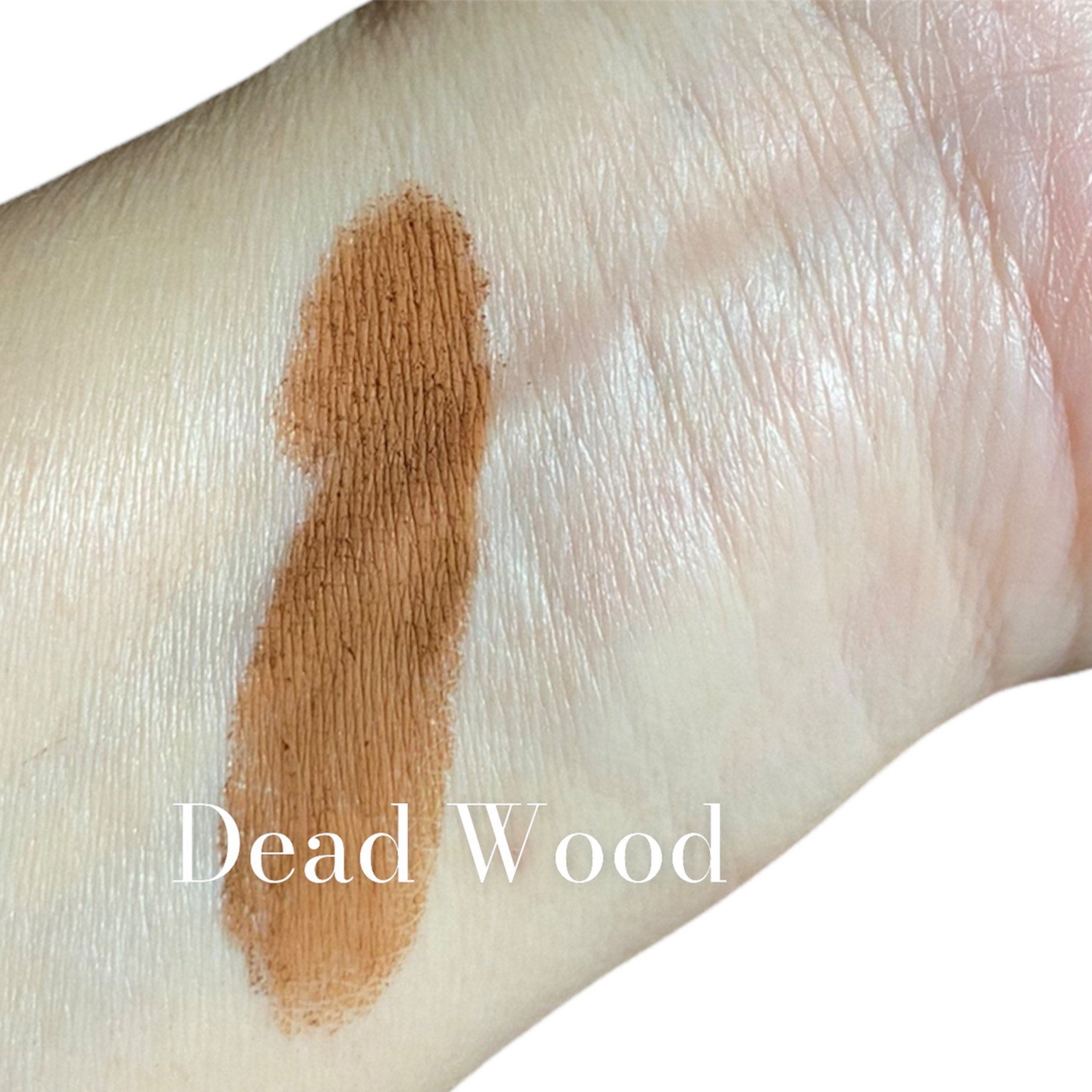 Close-up of matte taupe and light reddish brown mineral eyeshadow with smooth, blendable texture in compact