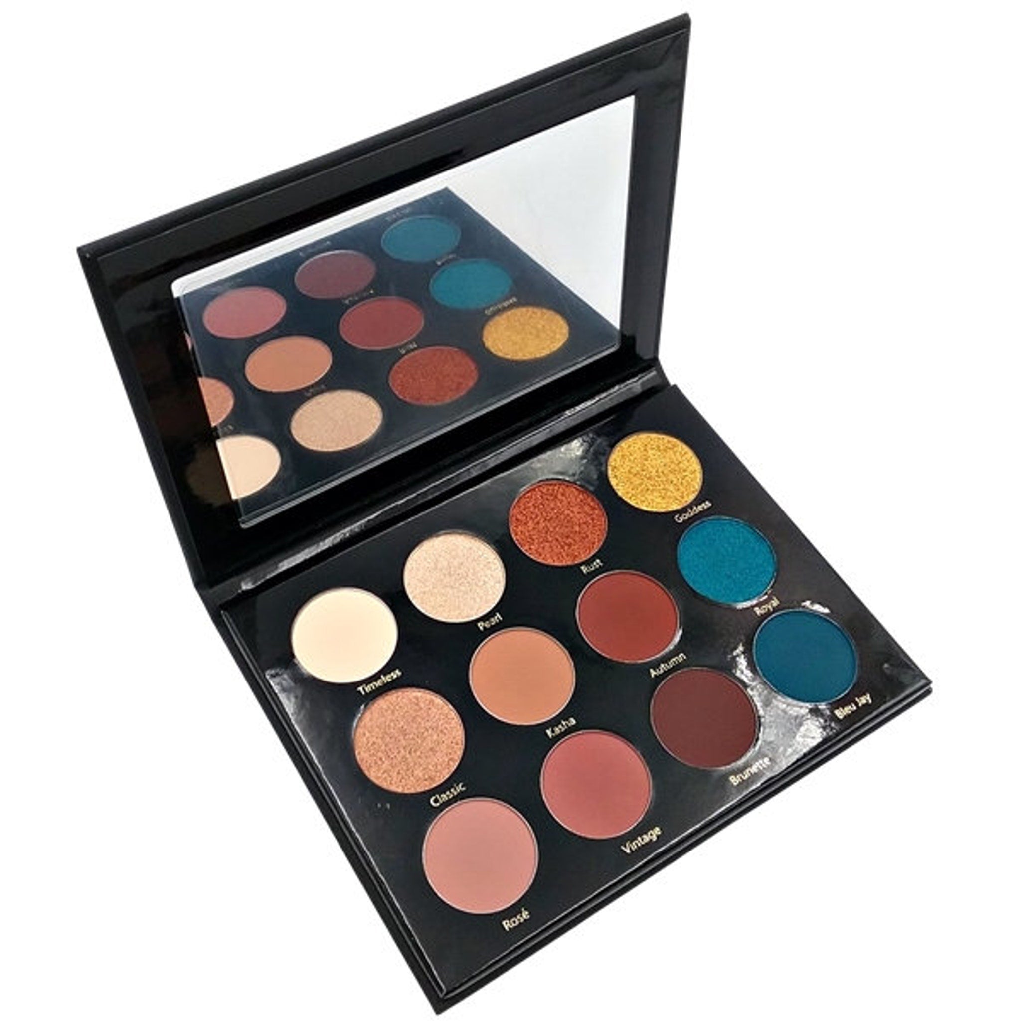 Hand applying shimmery bronze eyeshadow from palette to eyelid with blending brush