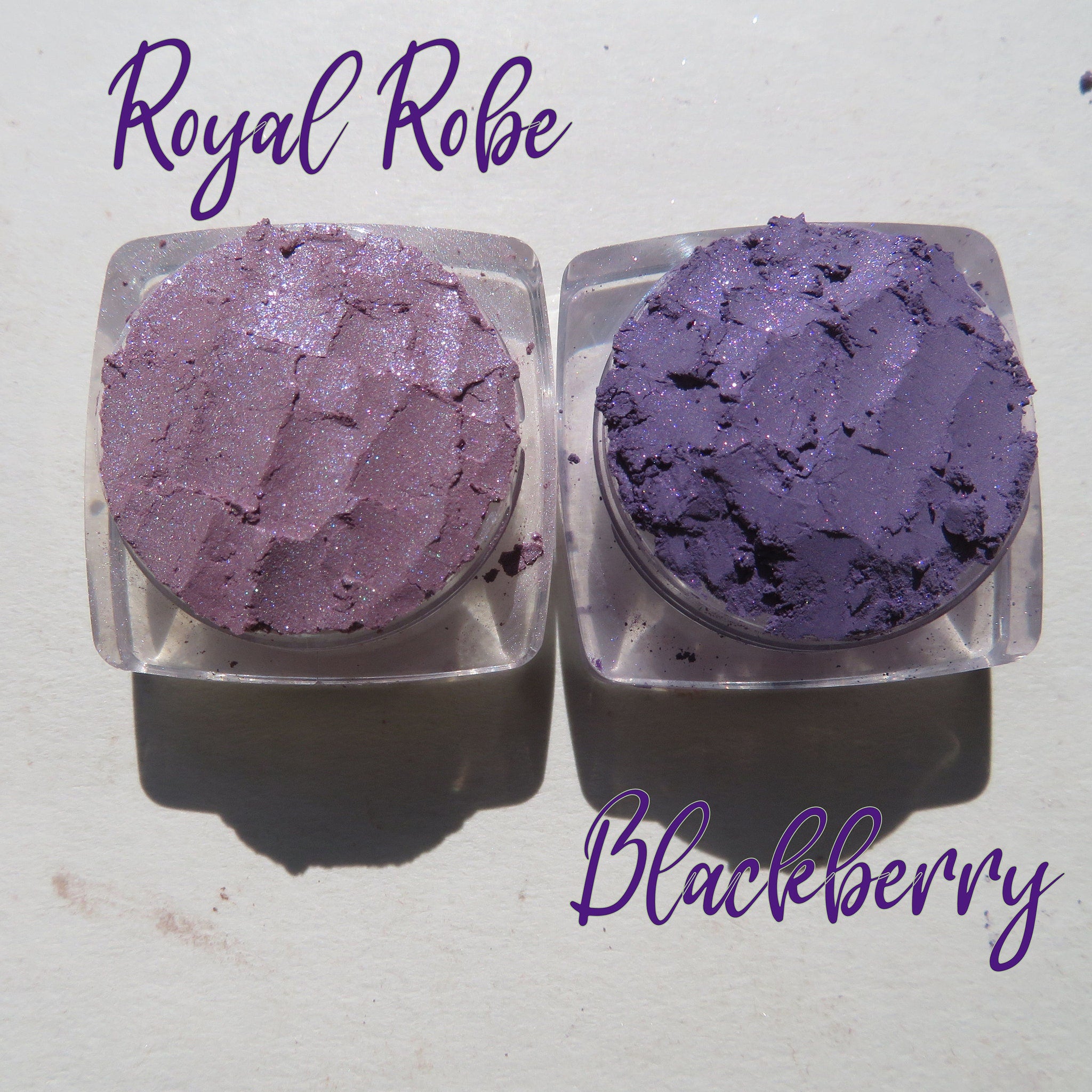 Side view of three purple shimmer loose pigment pots showing sparkling texture and vegan labels