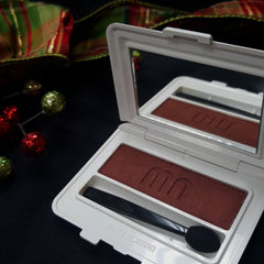 Merle Norman Luxiva single eye shadow compact in rich brown, soft pink, and deep purple shades with sleek mirrored case