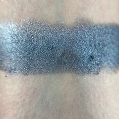 Single compact of matte gray eye shadow with sleek black packaging and silver logo