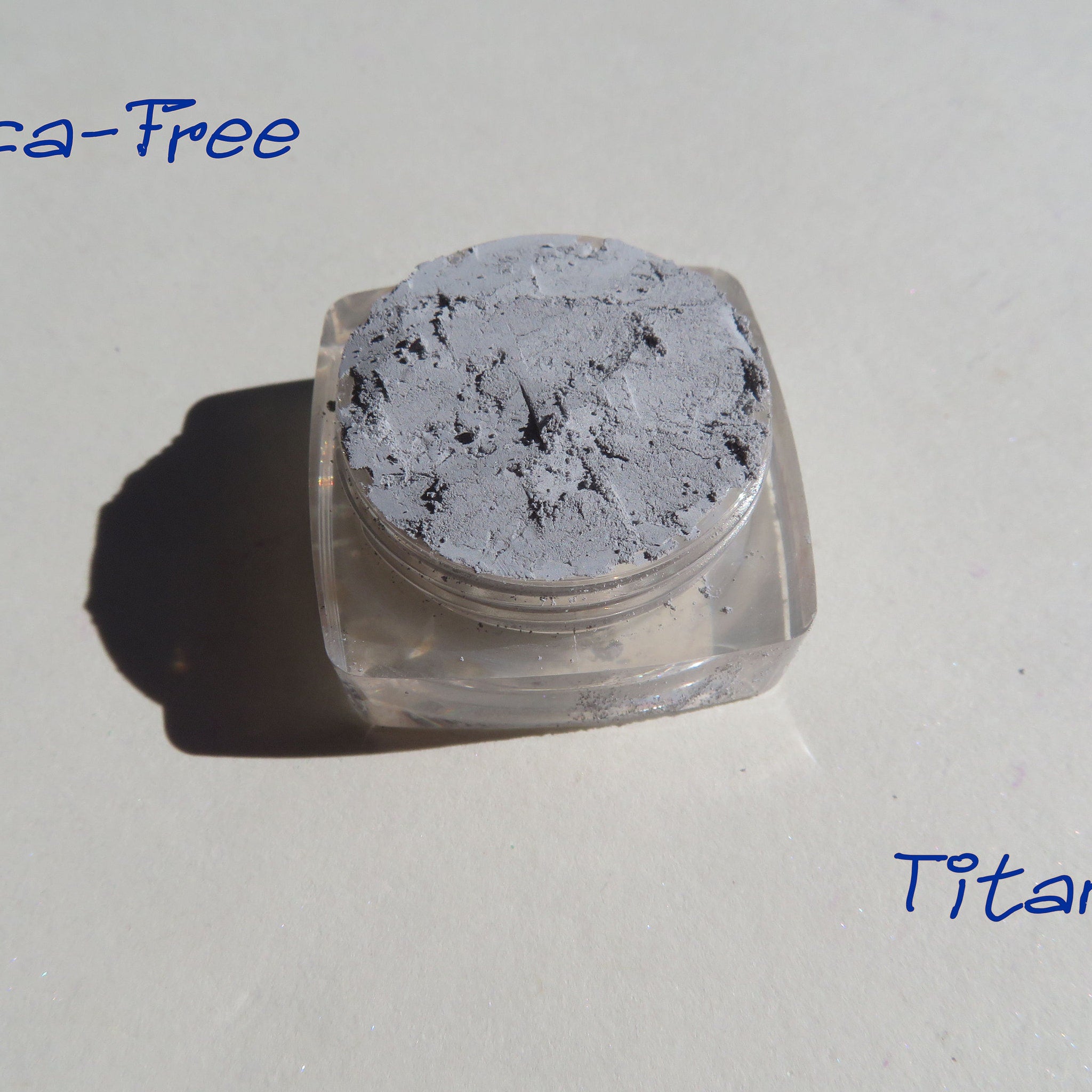 Matte gray loose pigment eyeshadow in minimalist eco-friendly packaging, vegan and mica-free