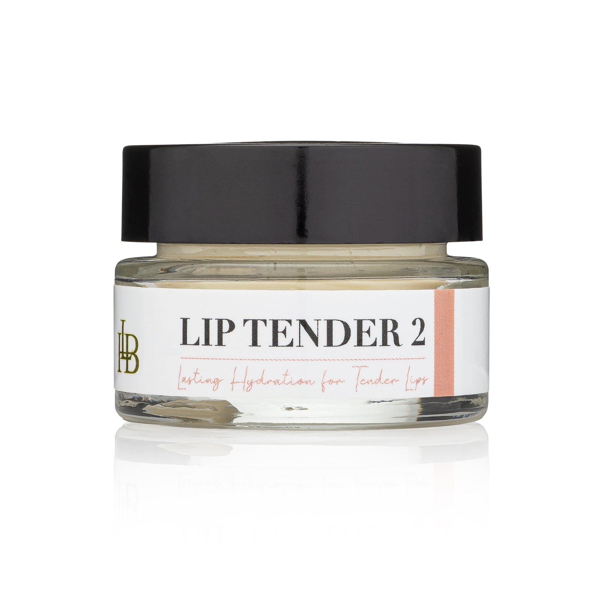 Lip balm jar with black lid, clear glass, and white label with text "LIP TENDER 2
