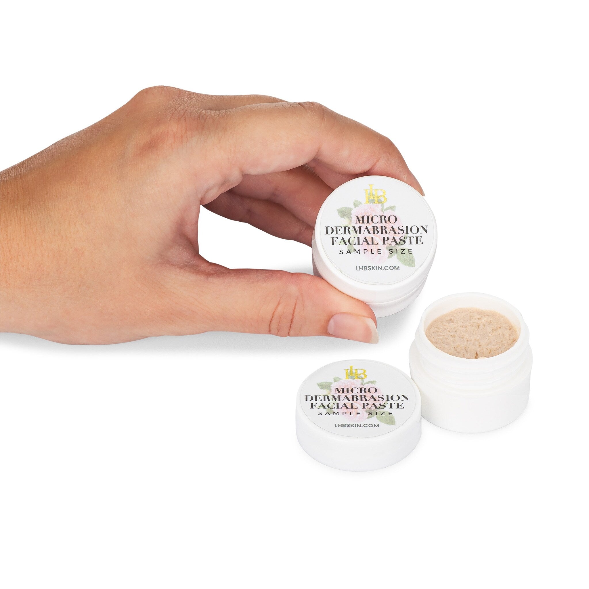 Microdermabrasion facial paste in white jar with beige paste and LHB SKIN text, held by hand