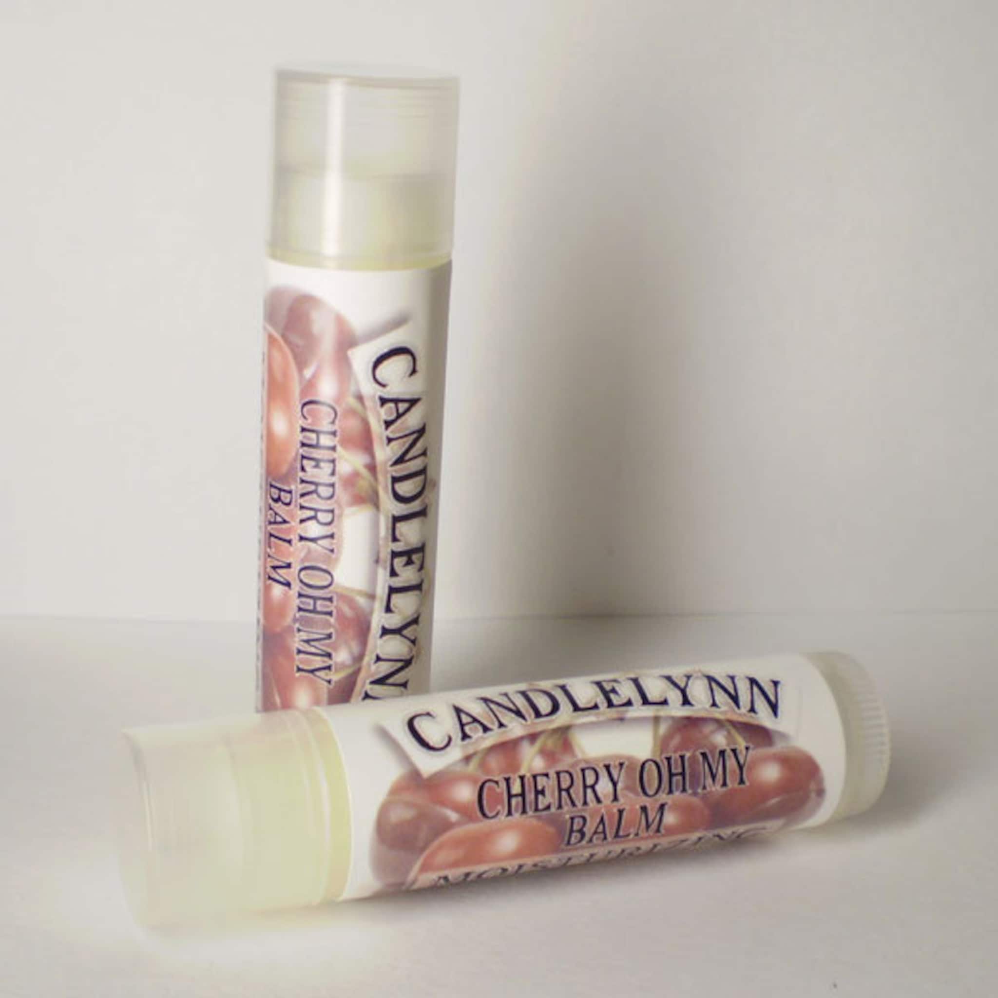 Lip balm tubes with white and cherry label, Candle Lynn brand name visible, clear cap