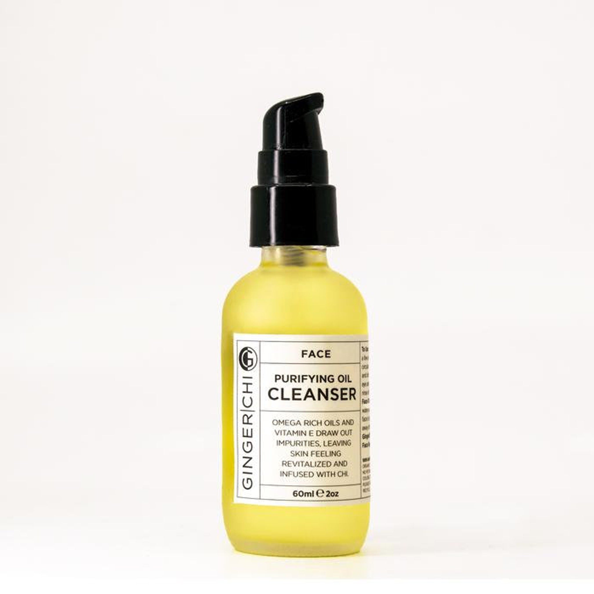 Facial cleanser bottle, yellow glass, black pump top, GingerChi label