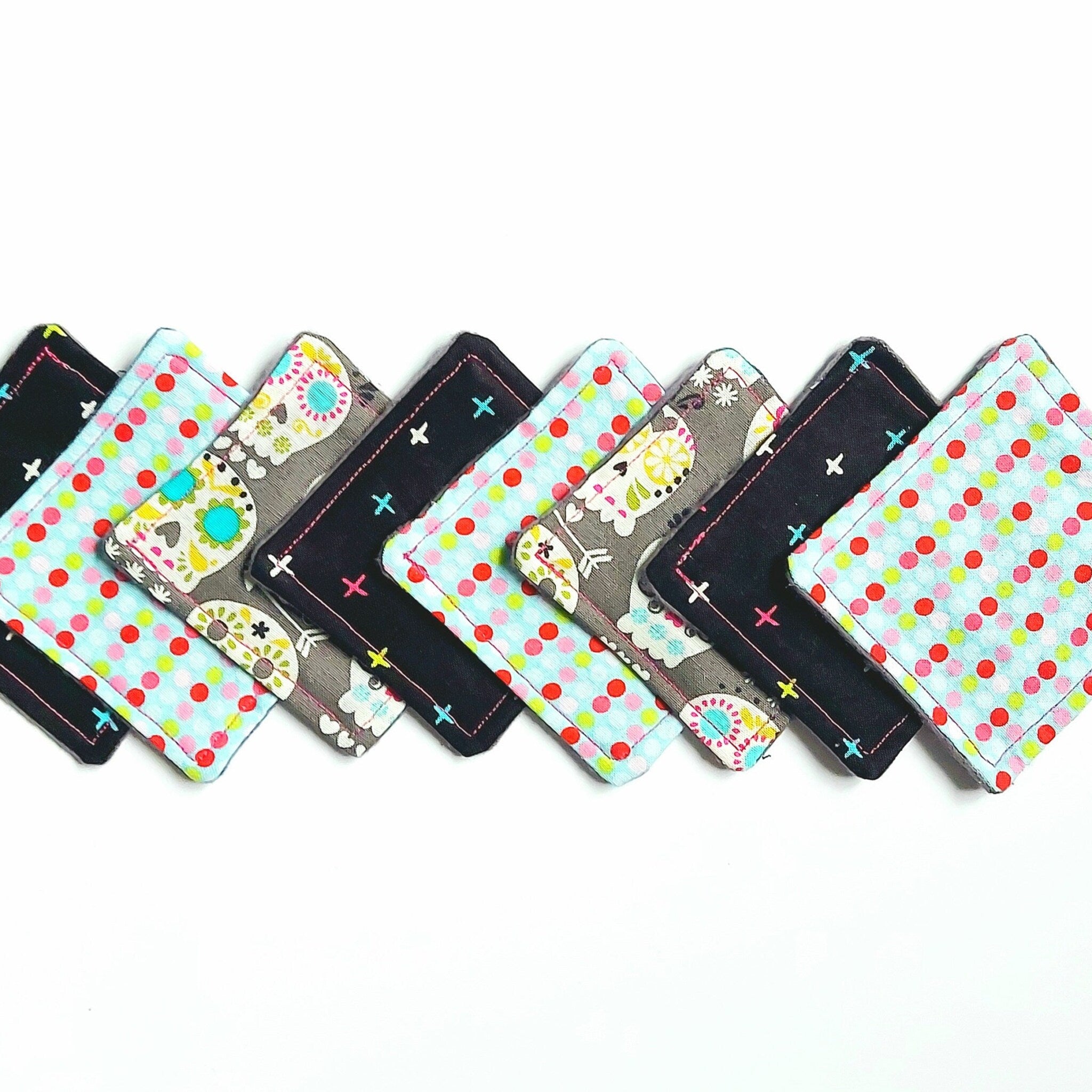 Cloth coasters with polka dot, floral, and cross patterns in various colors and styles