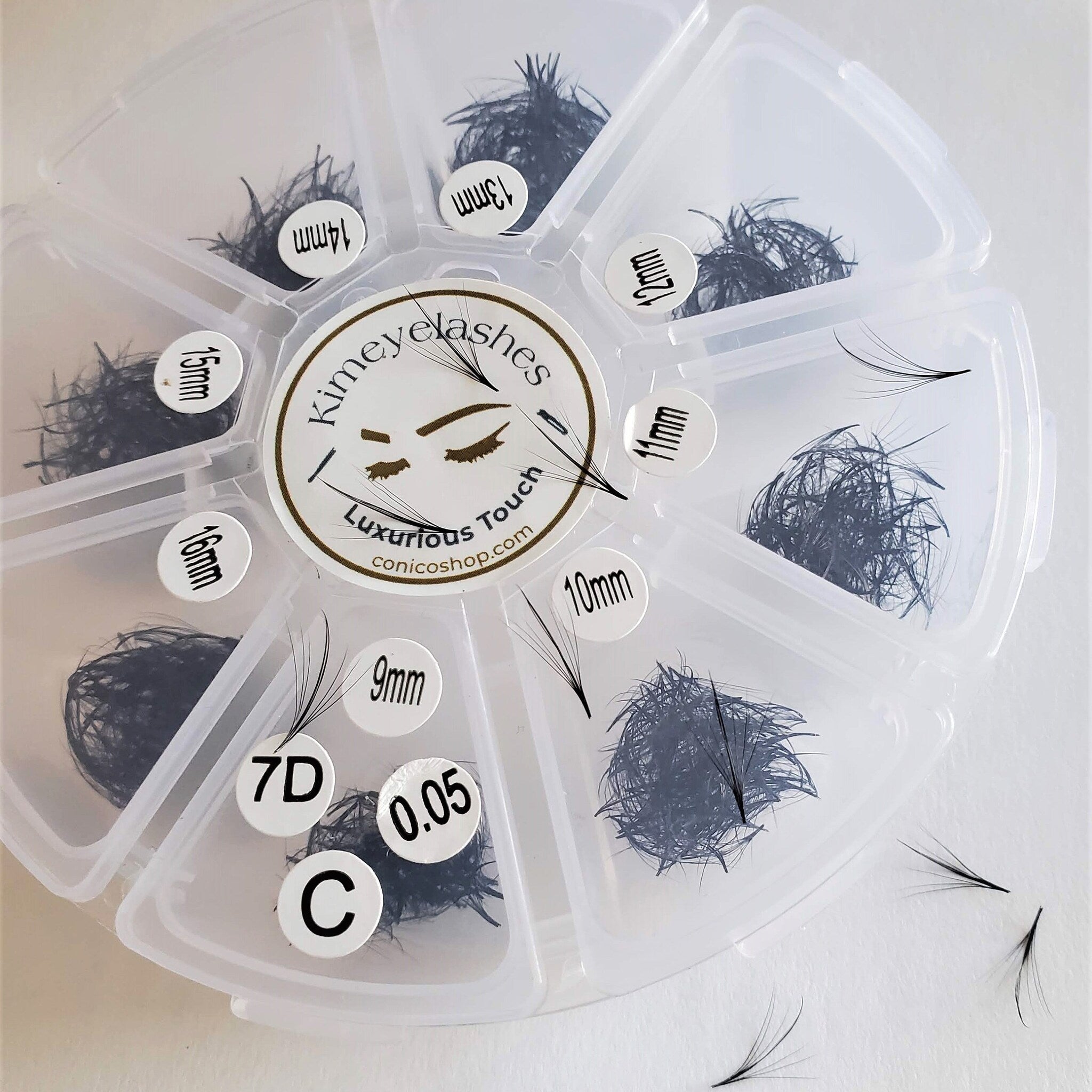 Eyelash extensions in black, with varying lengths, in a clear plastic organizer, Kimeyelashes brand