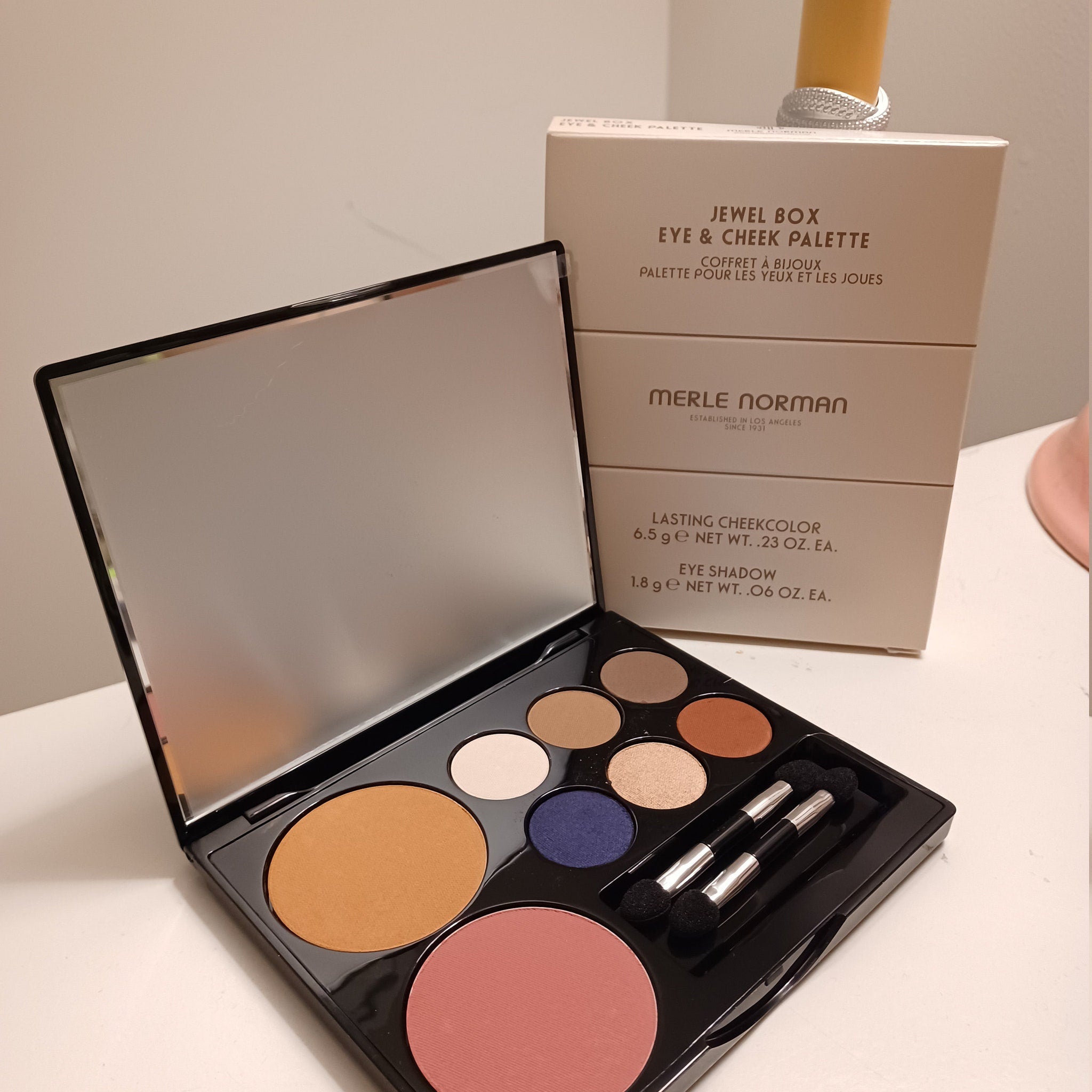 Side view of Merle Norman Luxiva compact showing six shimmering eyeshadow shades and two blush pans