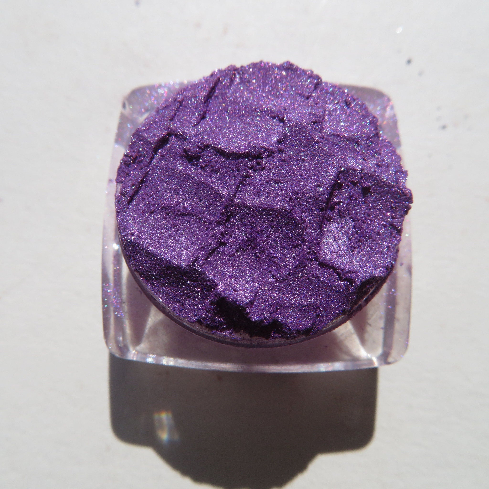 Purple mineral eyeshadow gift set with three shimmering loose pigments displayed in sleek black packaging