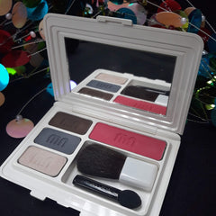 Face powder compact with white case, eyeshadow, blush, and Merle Norman branding