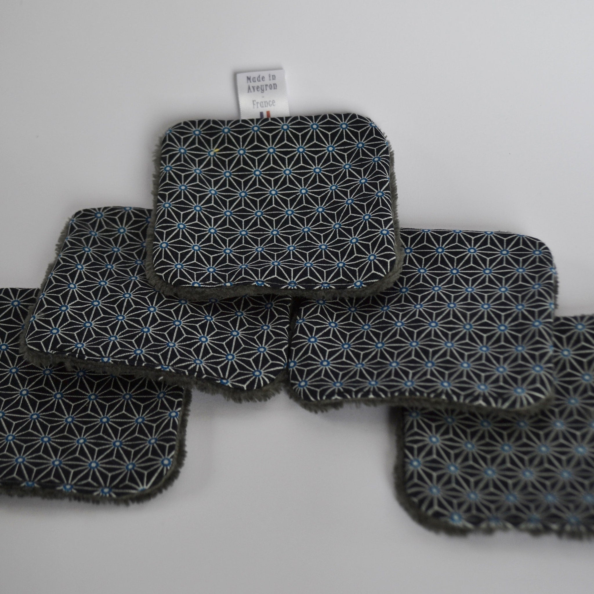 Coasters with geometric pattern, blue and white accents, and gray trim, Made in Aveyron France