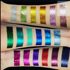 Glitter swatches in various colors, including silver, green, gold, and purple, applied to arm