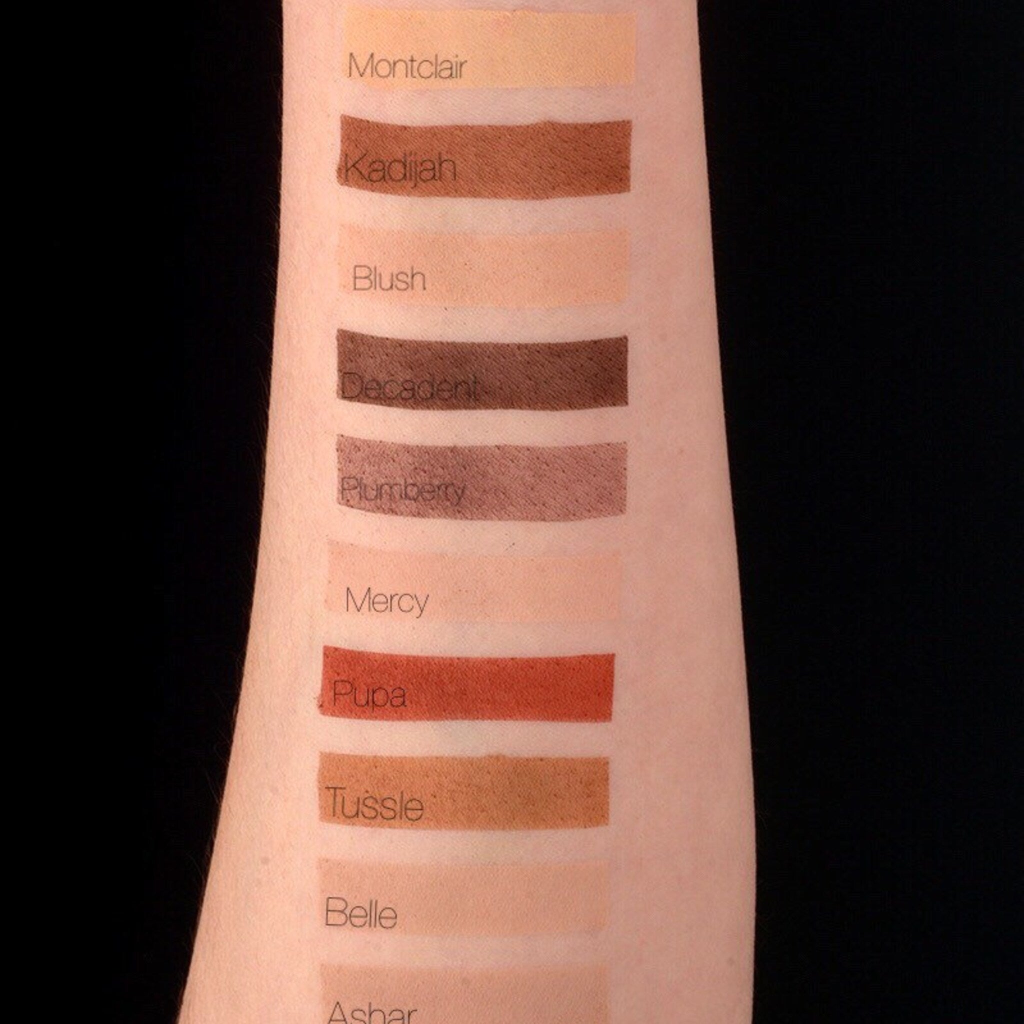 Swatches of various colors on arm, showing shades of brown, peach, and red