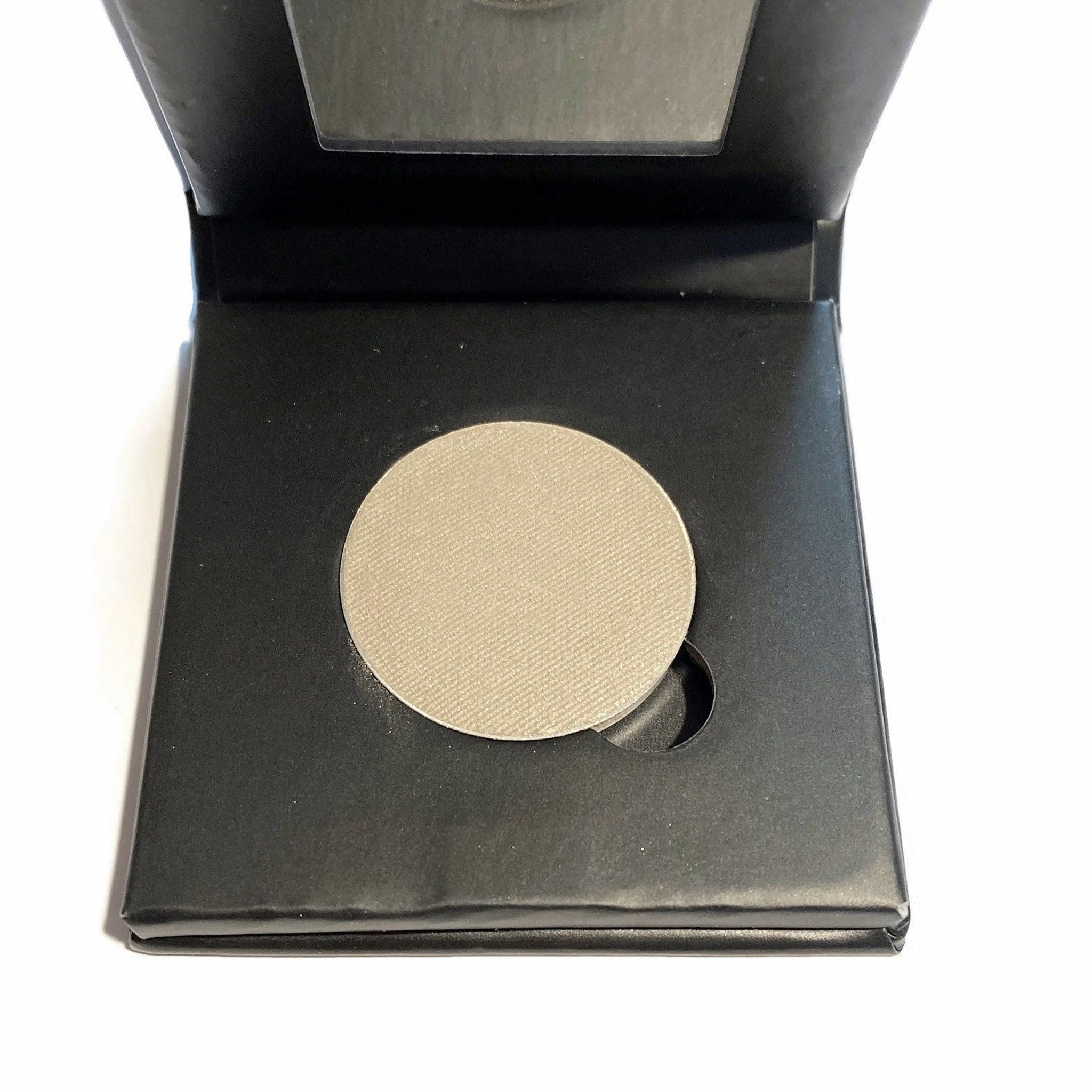 Platinum silver mineral eyeshadow compact with sleek mirrored case and shimmering powder pan