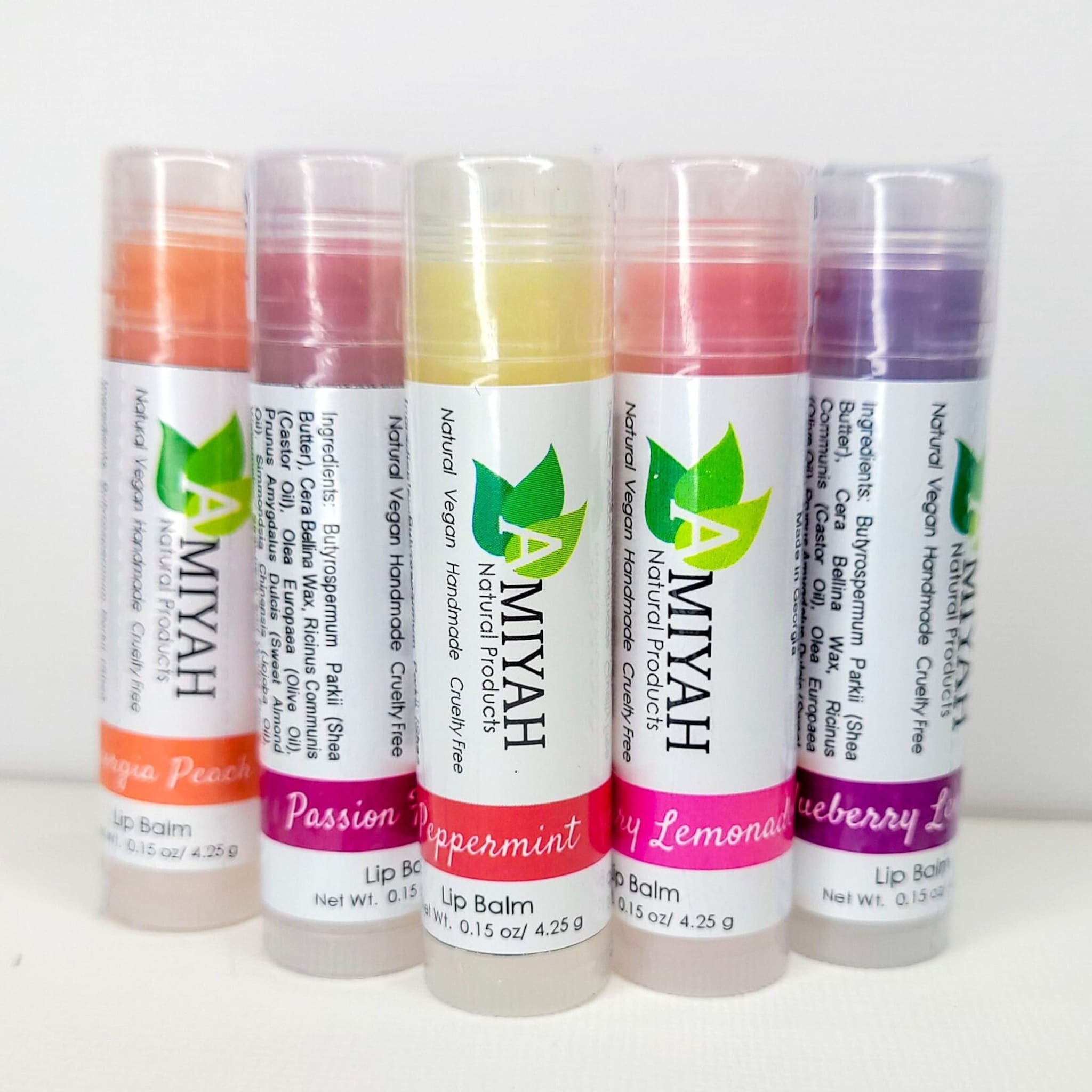 Lip balm bundle with colorful tubes, Amiyah Natural Products branding visible, and clear plastic caps