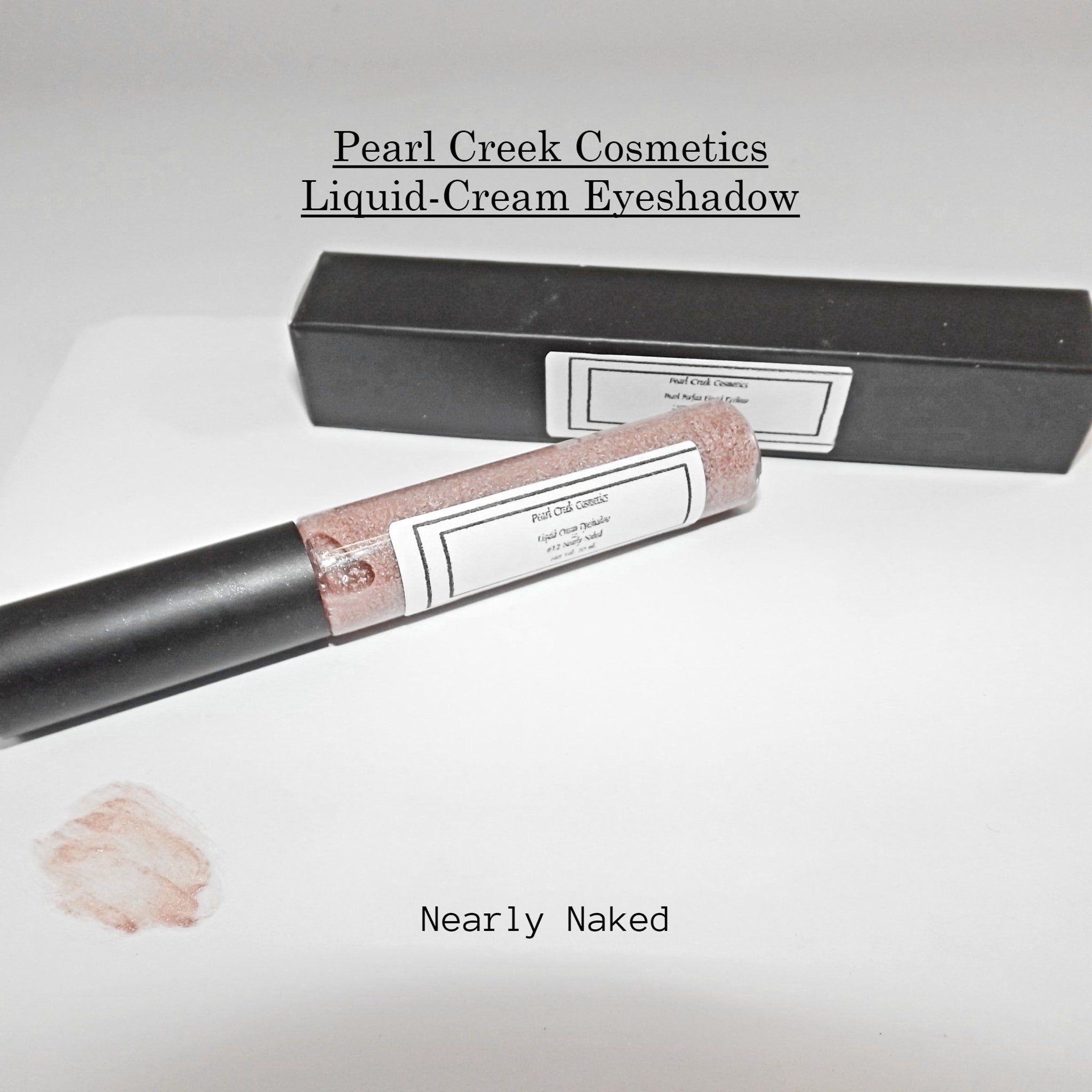 Close-up of creamy rose gold and nearly nude liquid eyeshadows with shimmer finish in sleek tubes