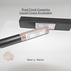 Close-up of creamy rose gold and nearly nude liquid eyeshadows with shimmer finish in sleek tubes