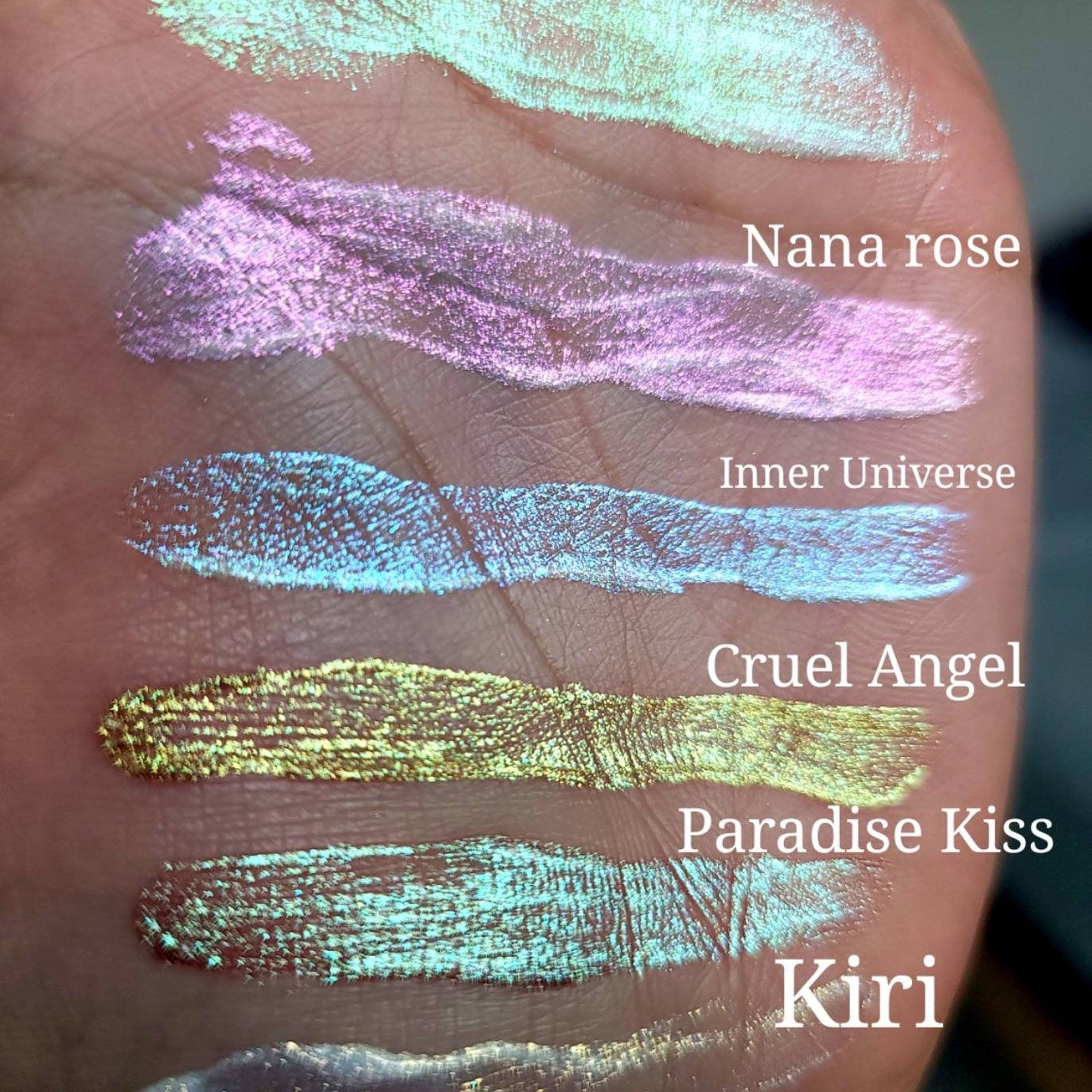 Side view of three chameleon duochrome liquid eyeshadows in sleek tubes showcasing shimmery vegan formula