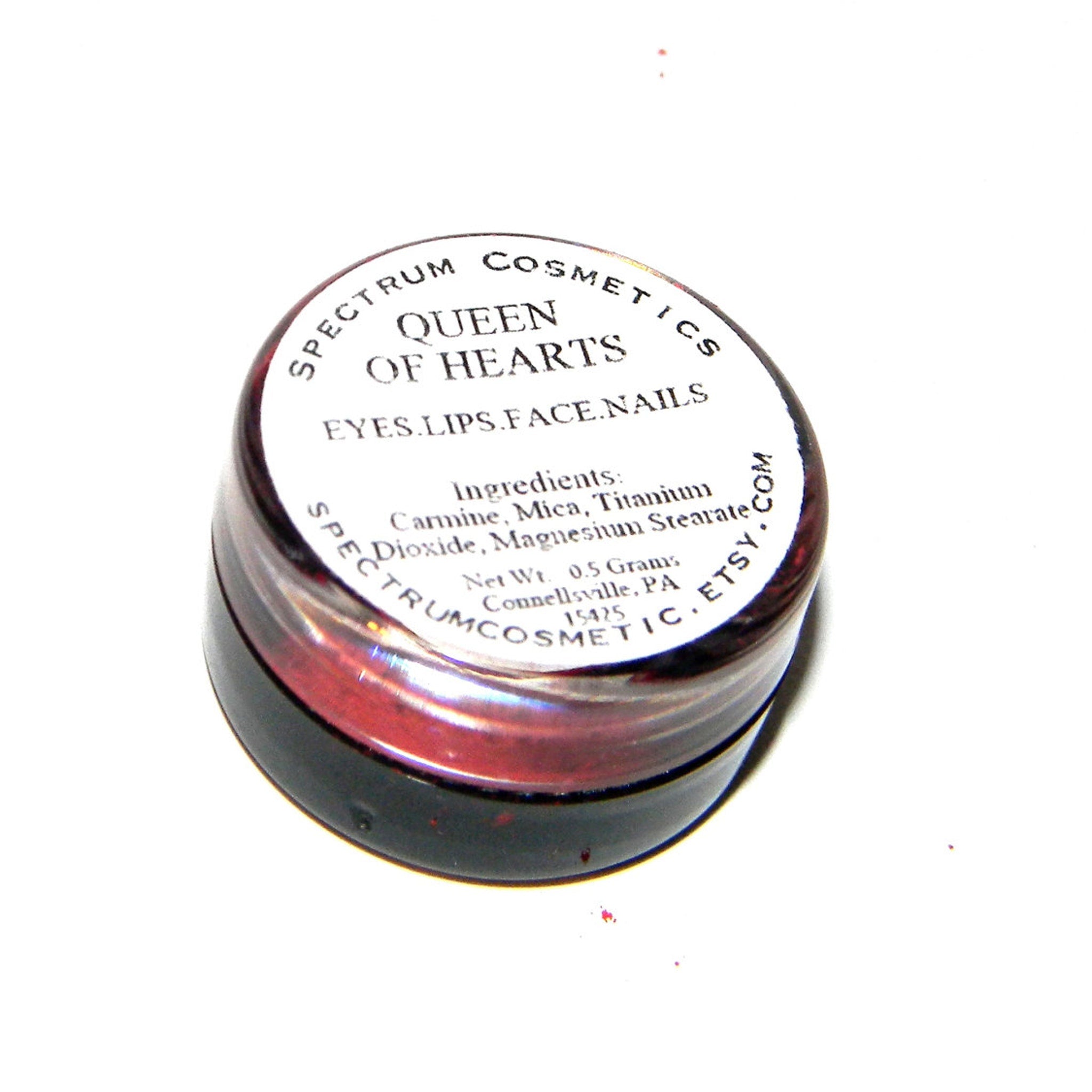 Queen of Hearts red matte eyeshadow compact with gold detailing and heart-shaped logo on sleek black case