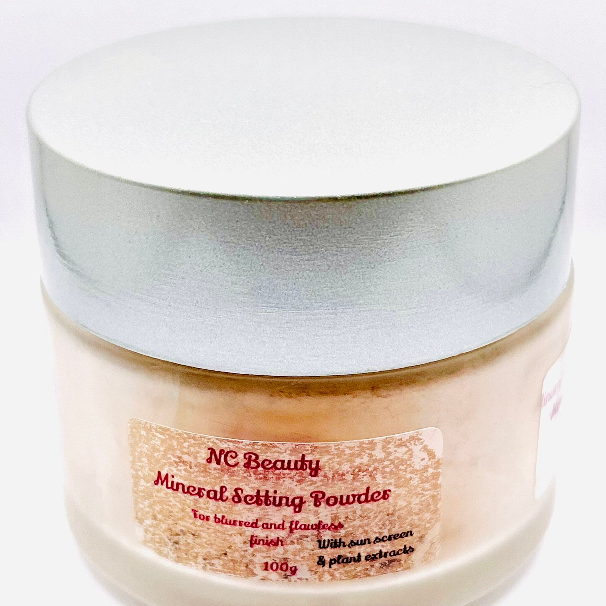 Mineral setting powder jar with silver lid and beige label, NC Beauty branding visible