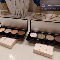 Side view of Merle Norman Eye Color Quad showing four complementary powder shadows in a sleek black compact