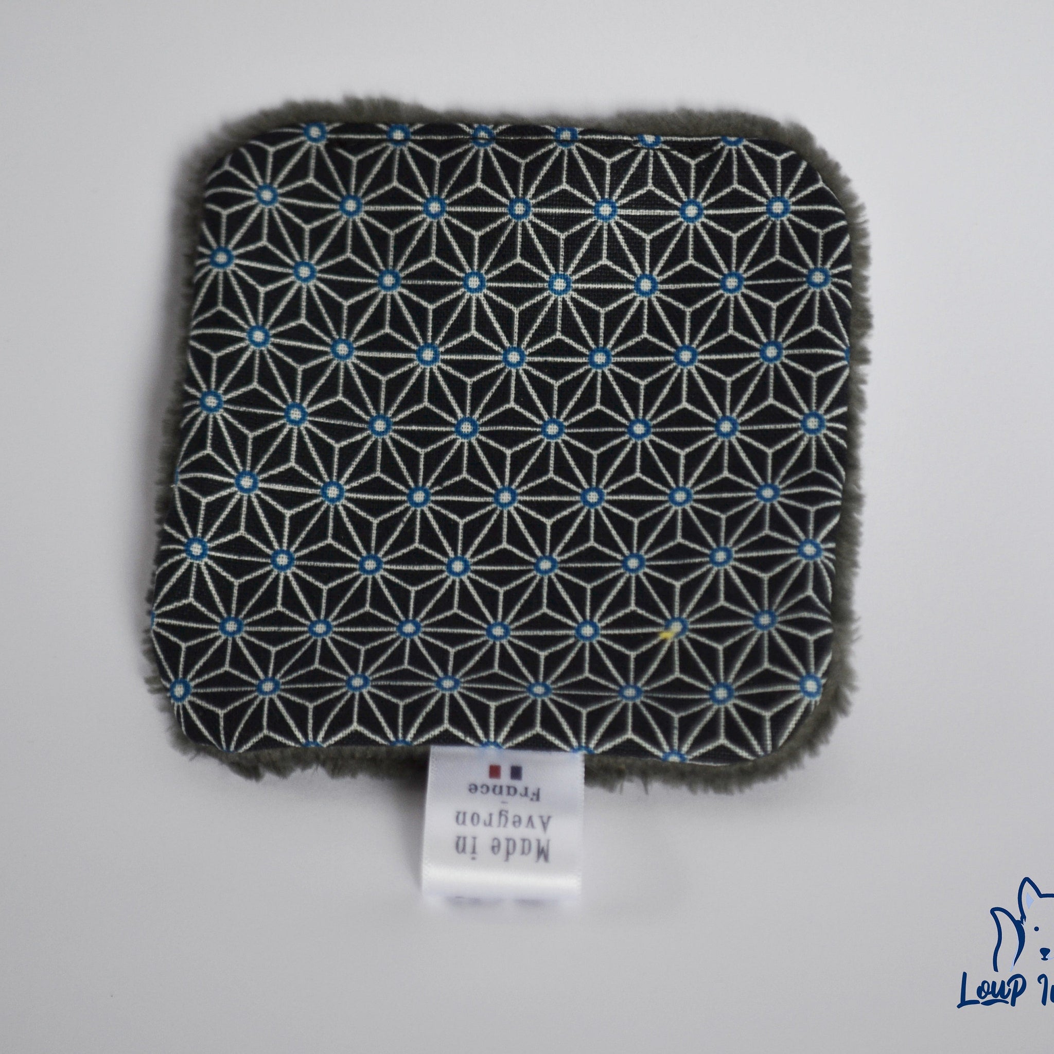Black patterned fabric with blue accents and gray trim, Loup Indigo label visible