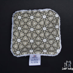 Reusable pad with geometric pattern, tan and white, with white trim and Loup Indigi logo